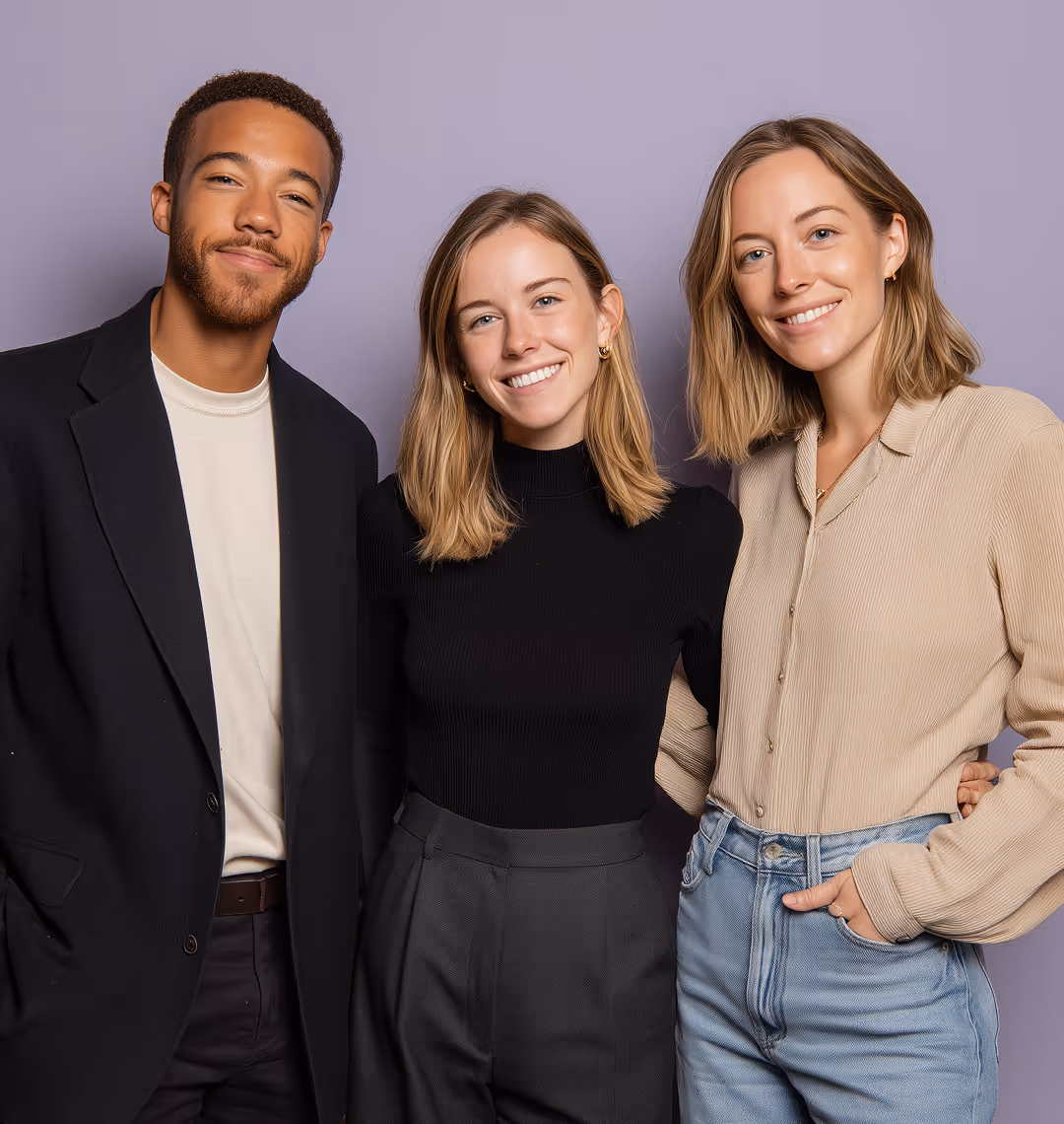 Three young adults smiling and standing together against a purple background, wearing casual and semi-formal clothing.