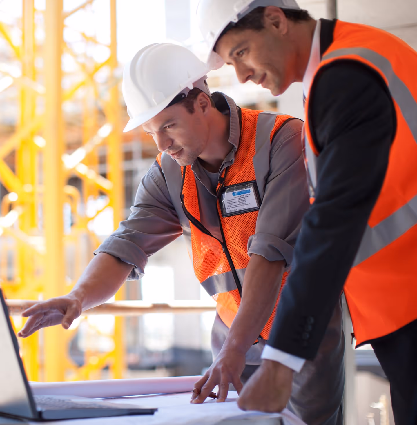 Construction workers looking at computer screen
