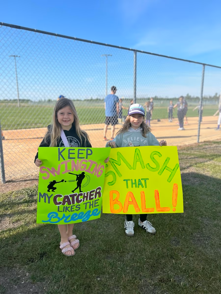 Young fans holding homemade signs