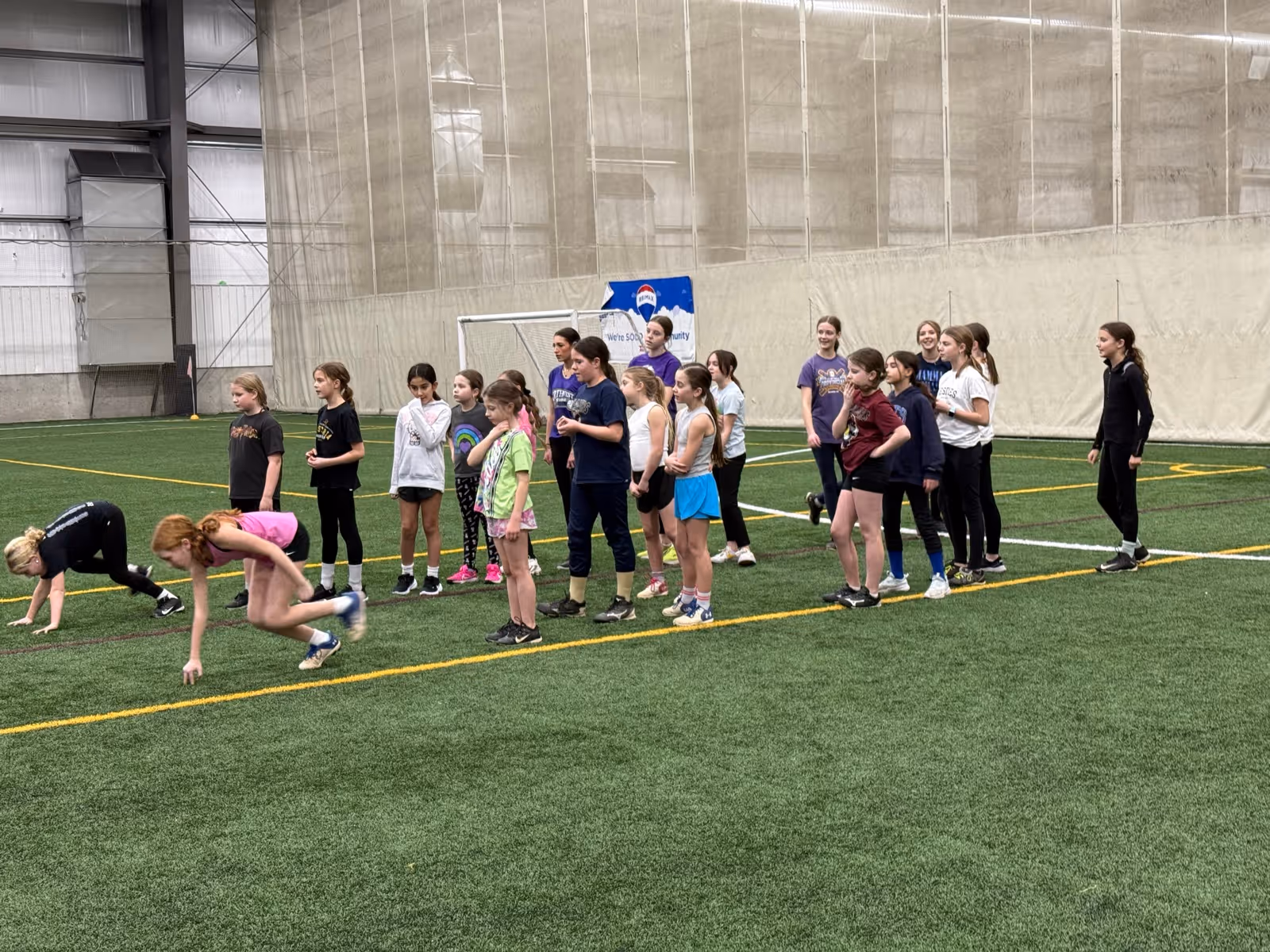 Players lined up on the turf during practice