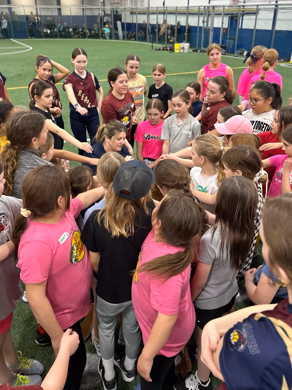 Players huddled together with hands in the center
