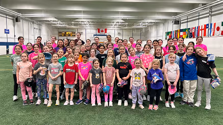 Excited players in jerseys by the backstop