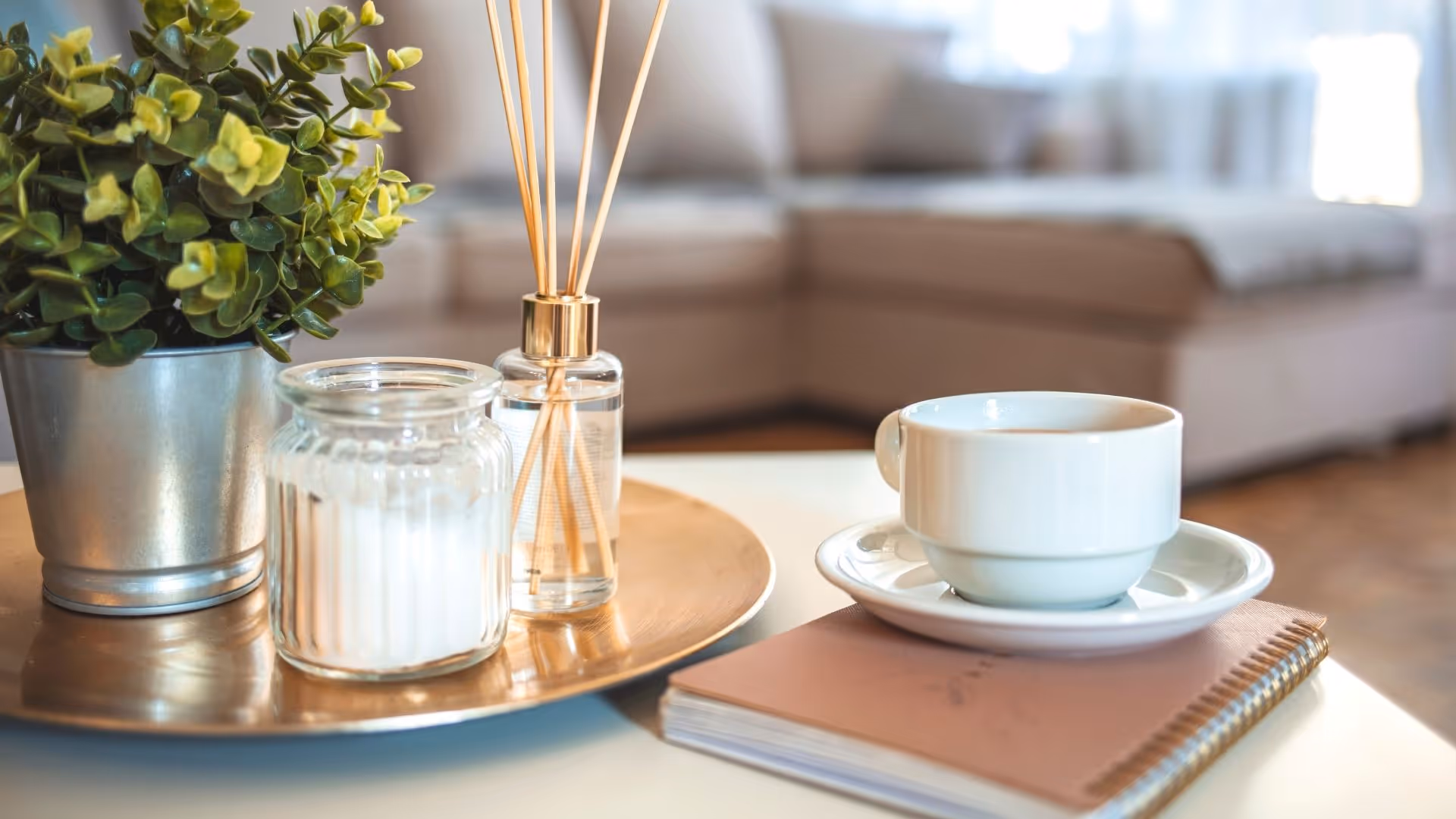 Decor featuring mug, notebook, and plant on table stock image