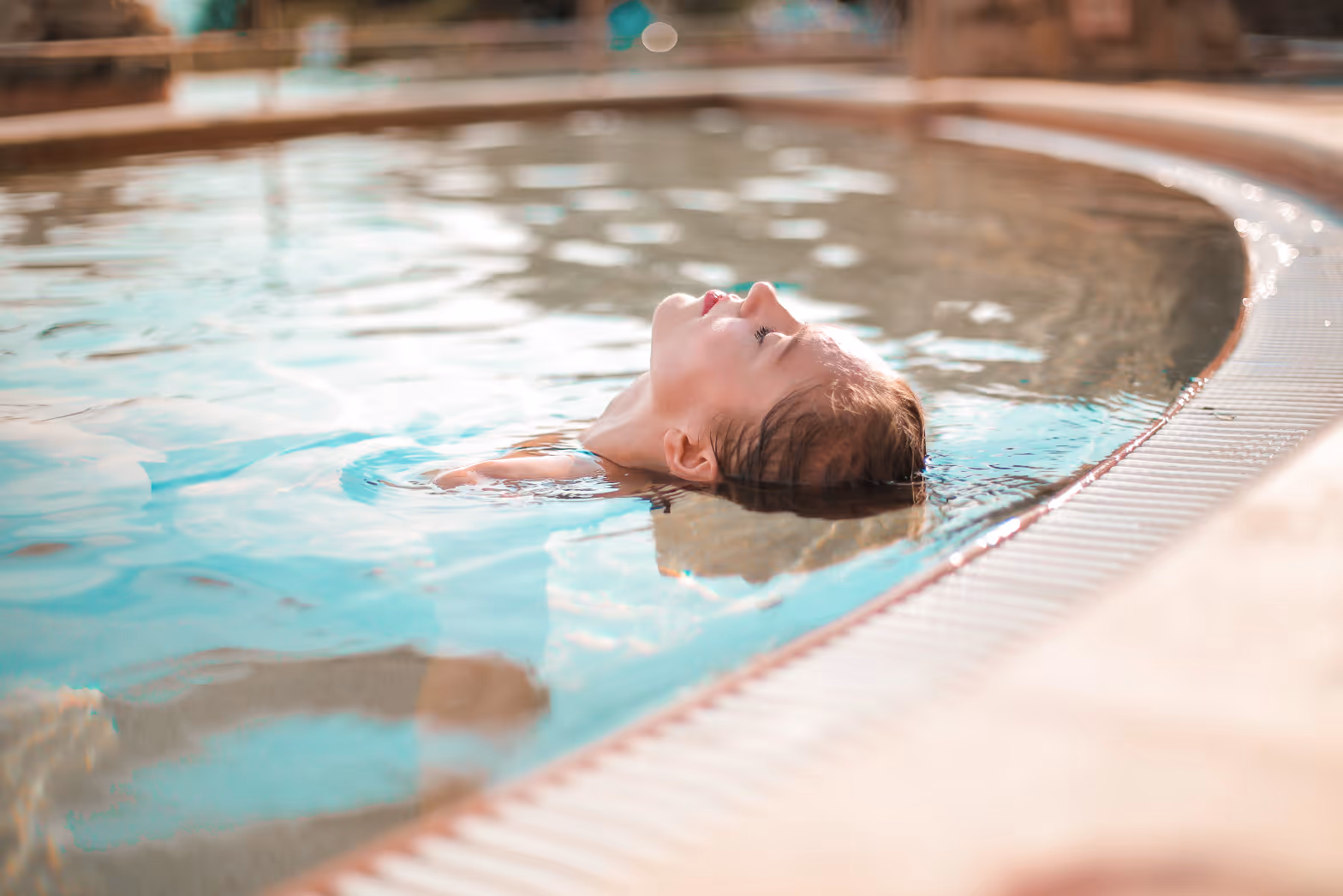 Woman floating in pool stock image