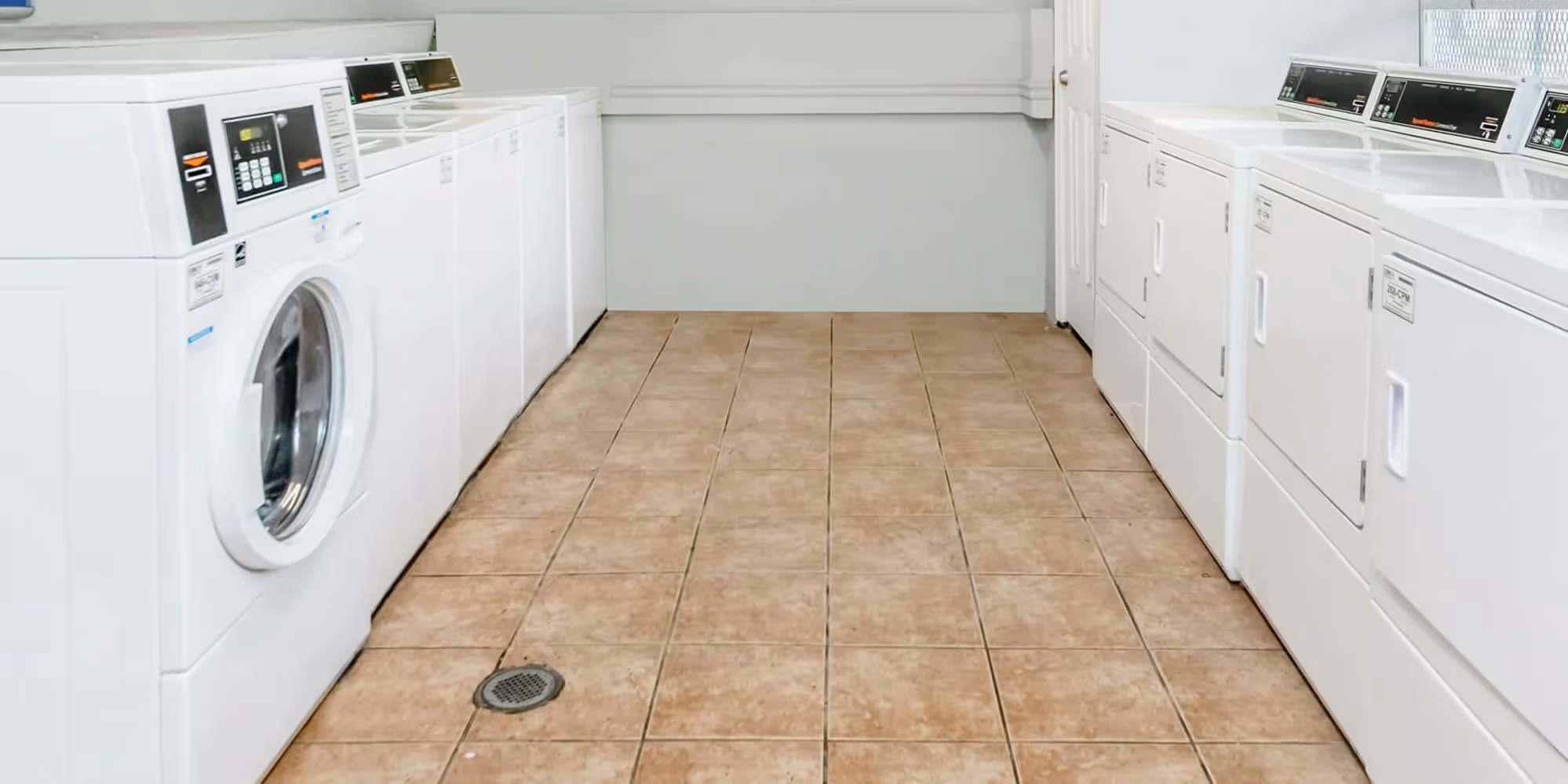 Laundry room with white washing and dryer machines