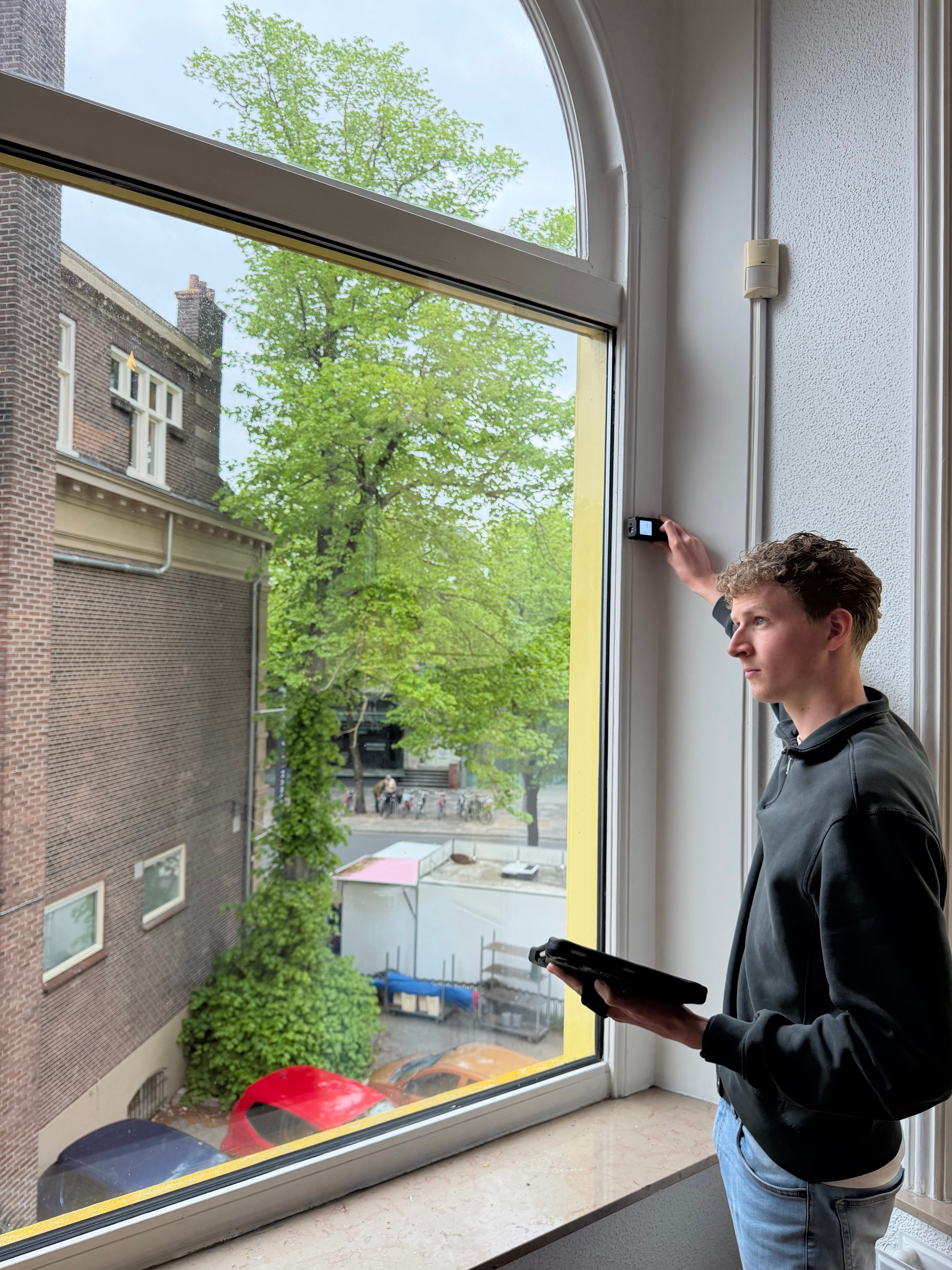 Energieadviseur meet een boograam op tijdens een woningopname