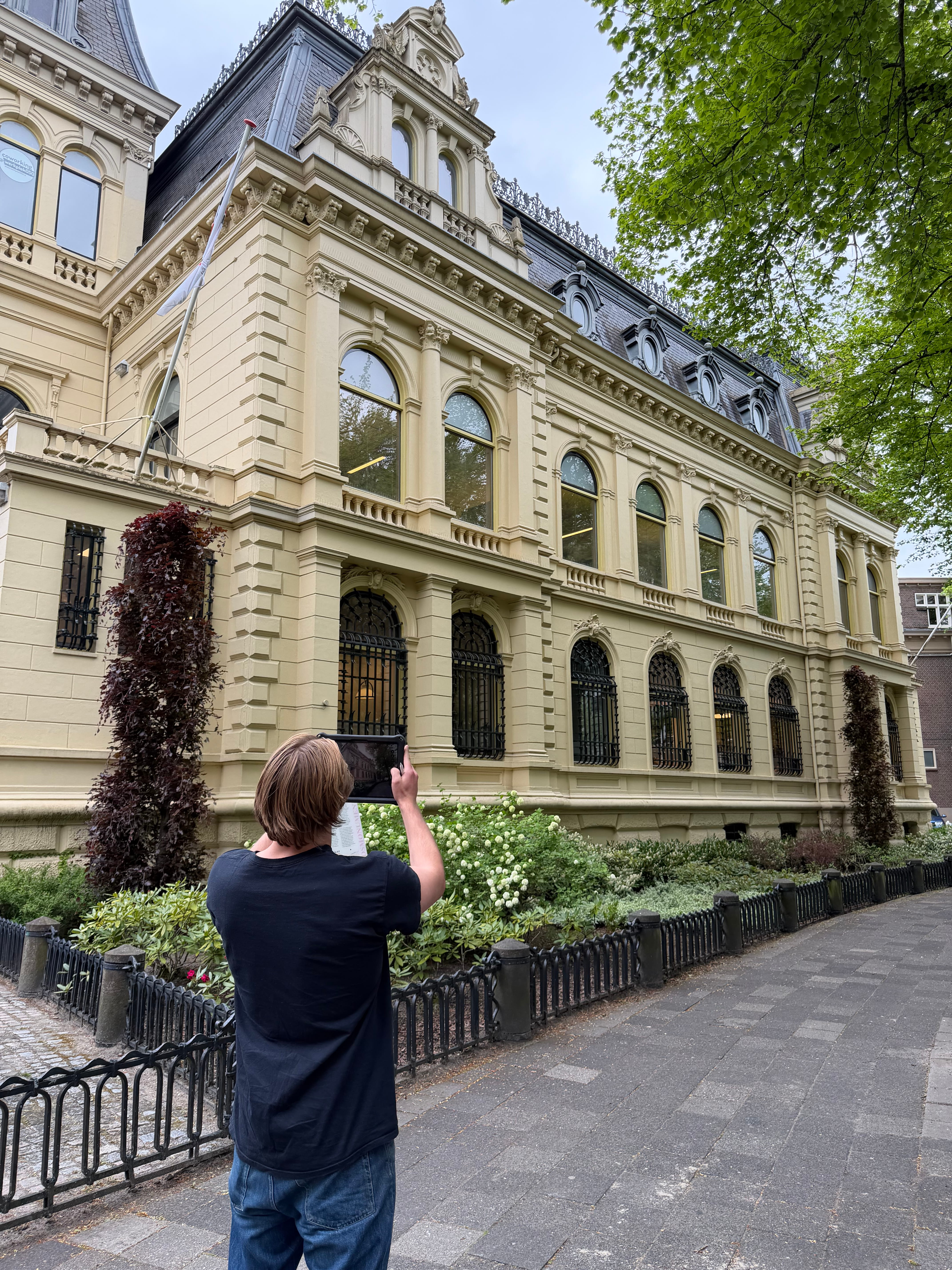 Energieadviseur fotografeert de gevel van een monumentaal pand tijdens een opname