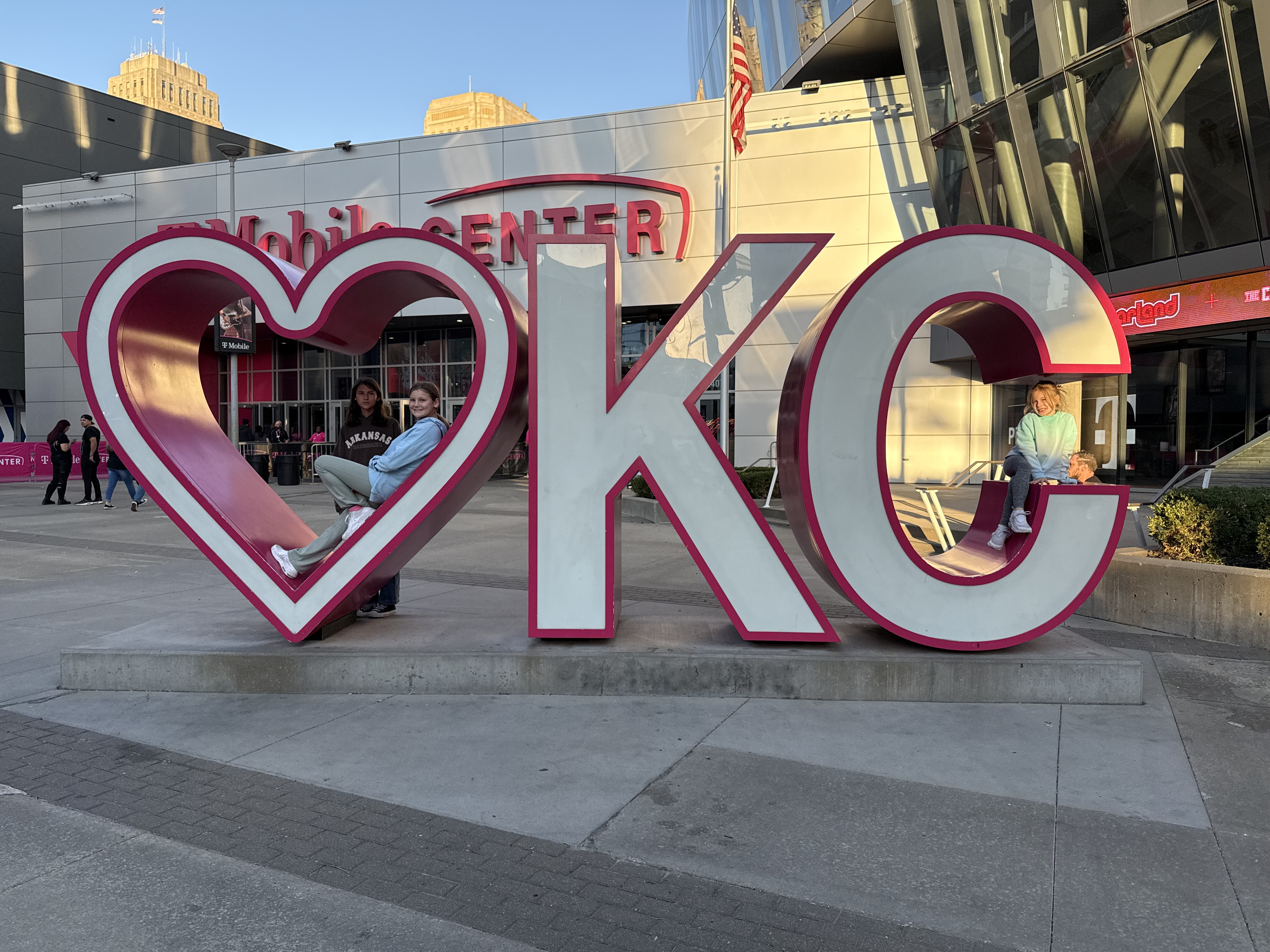 James Roberts’ daughters posing with a "Heart KC" sculpture, reflecting TrueSpan Group’s deep family roots and commitment to the Kansas City community.