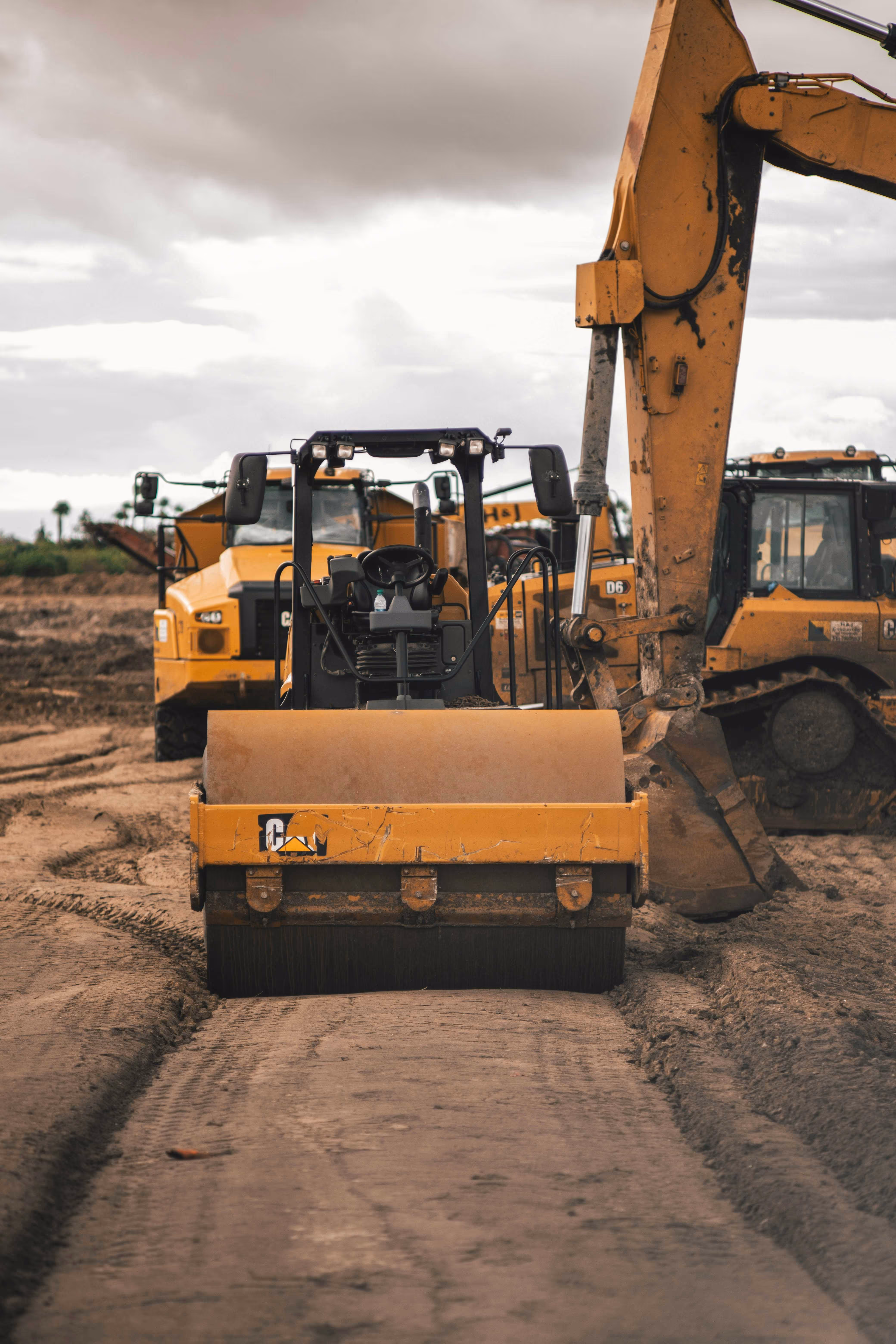 Heavy construction equipment, including a steam roller and excavator, on a Kansas City job site—insured by TrueSpan Group’s Inland Marine coverage.