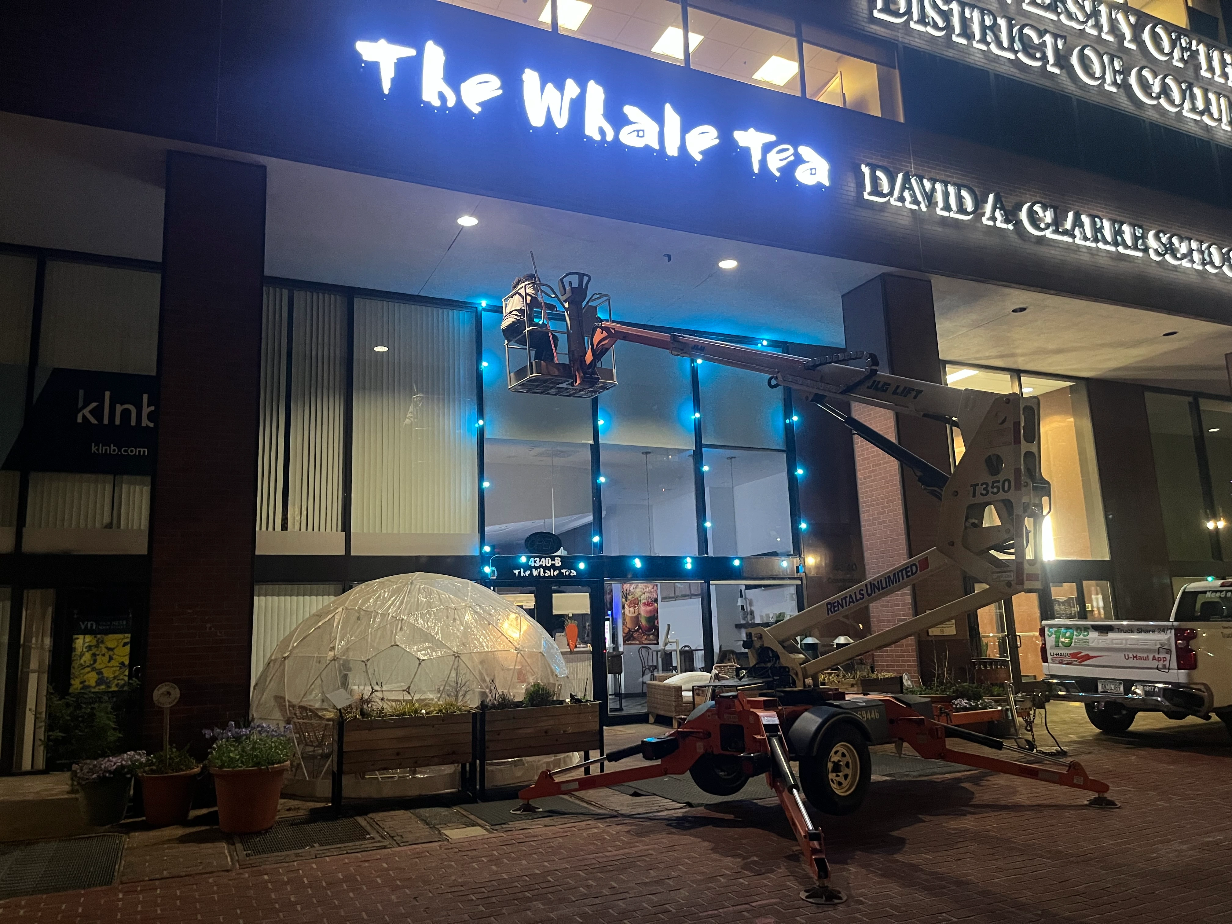 Illuminated shop signs for storefront branding and nighttime visibility