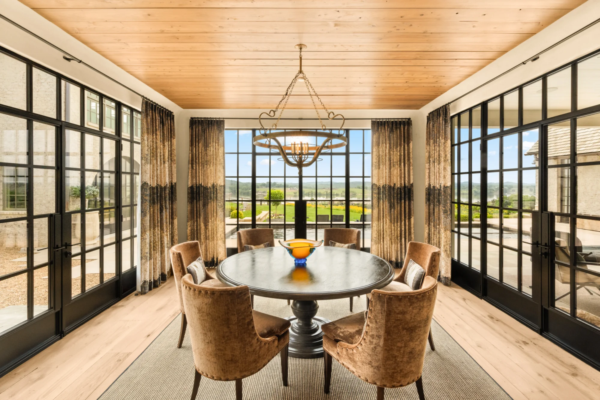 Glass-walled dining room with round table