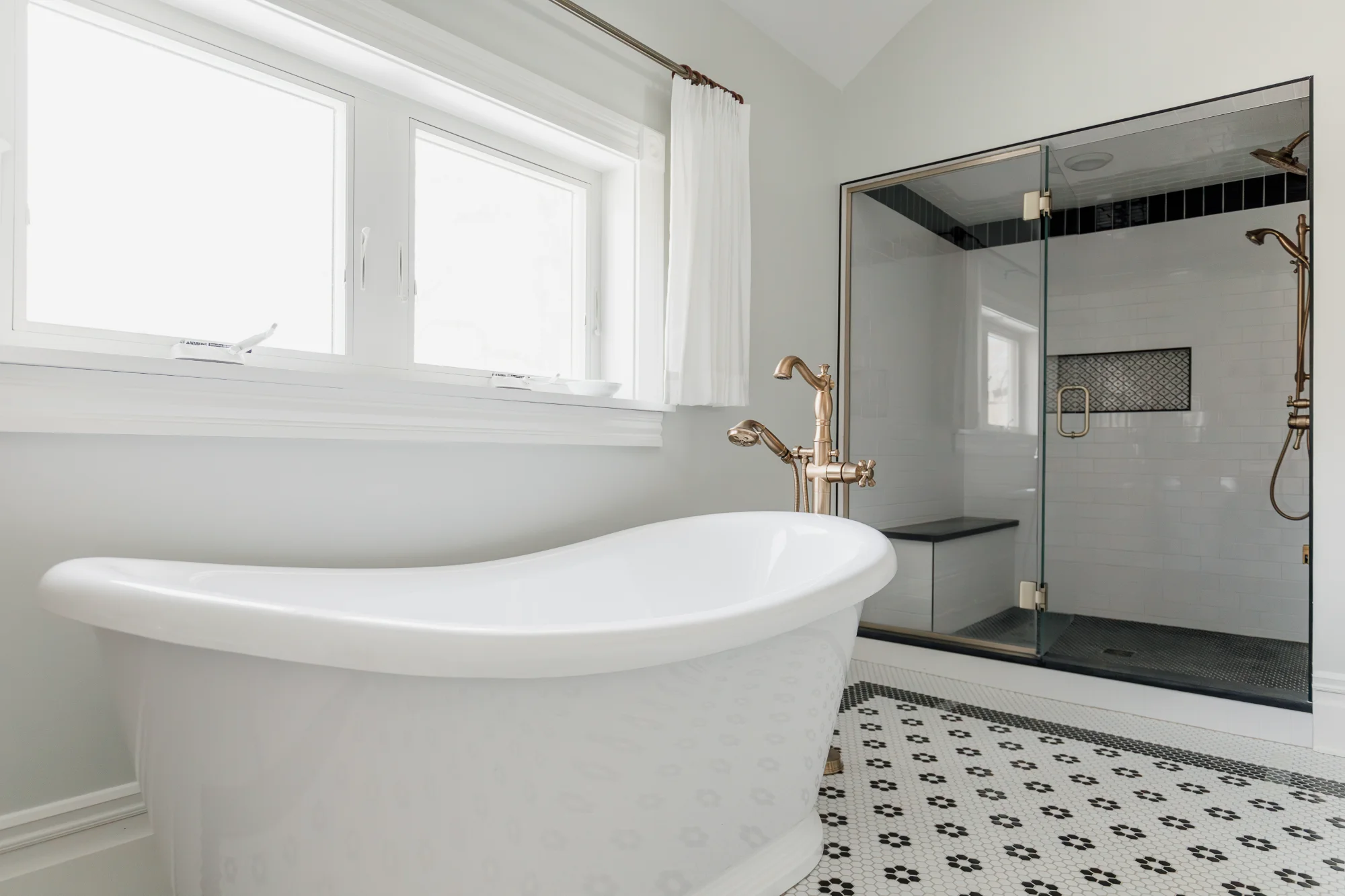 Freestanding soaking tub in corner by window