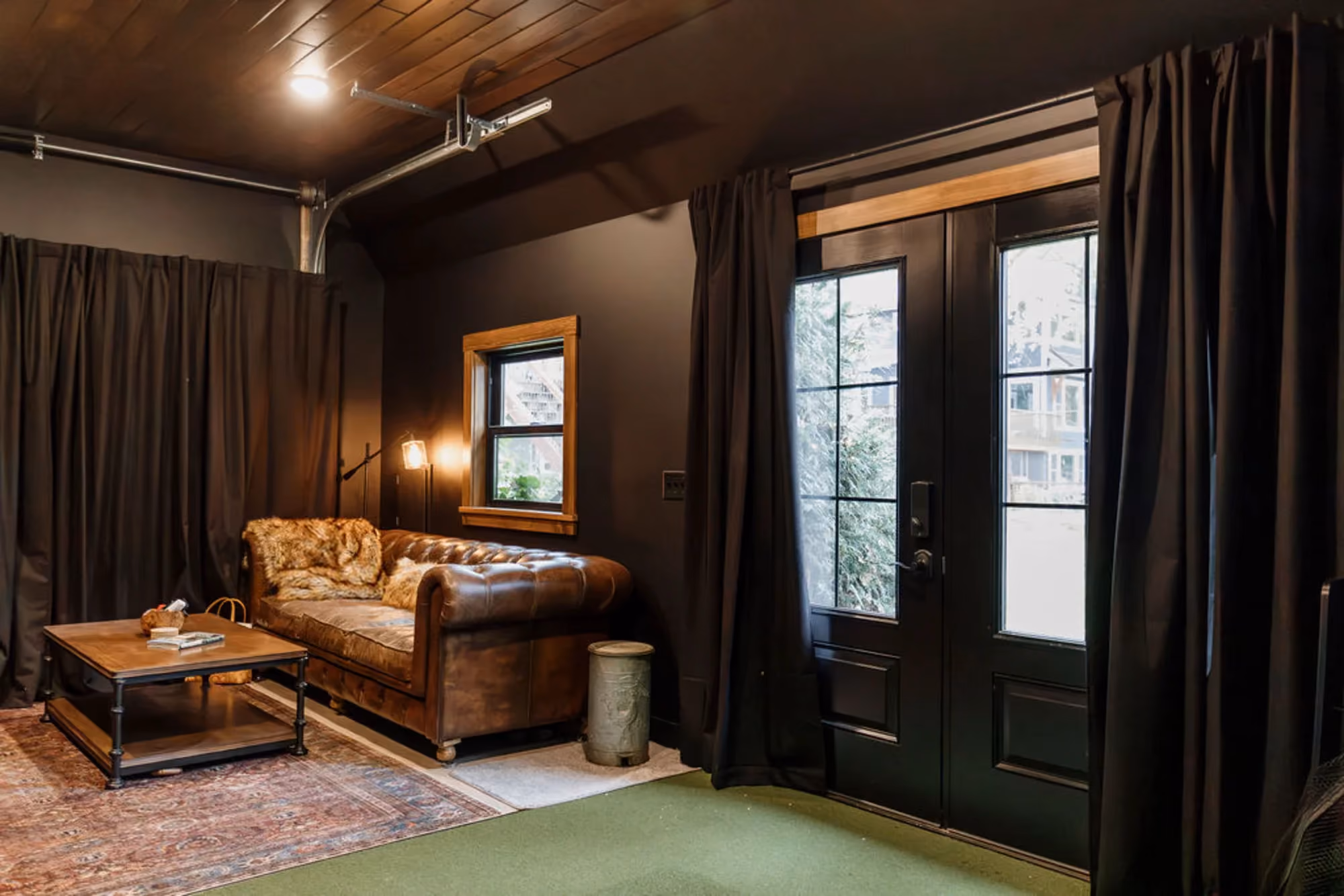 Cozy living room with leather sofa and dark curtains