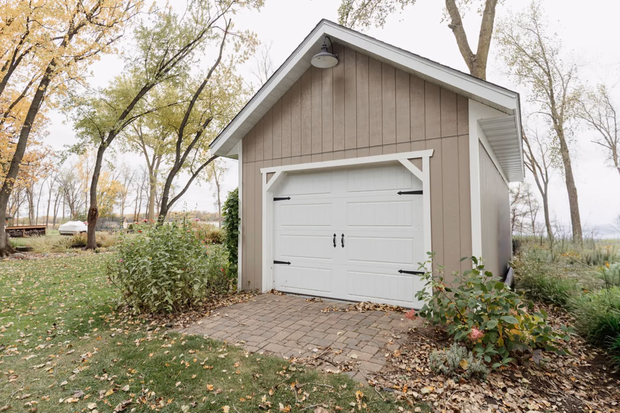 Detached garage exterior with white door - 2