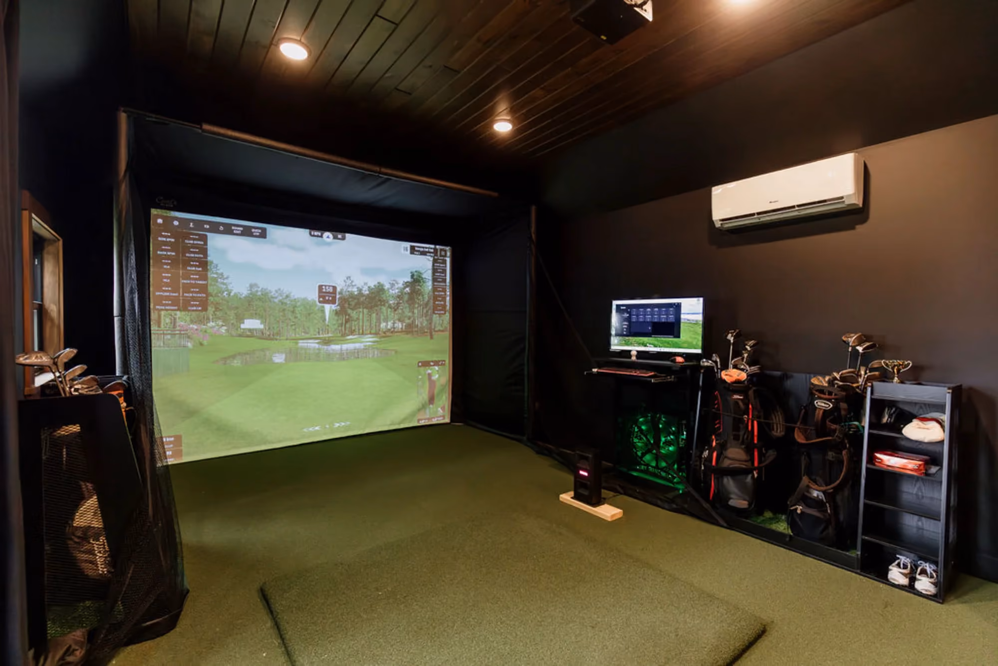 Indoor golf simulator room with projector screen