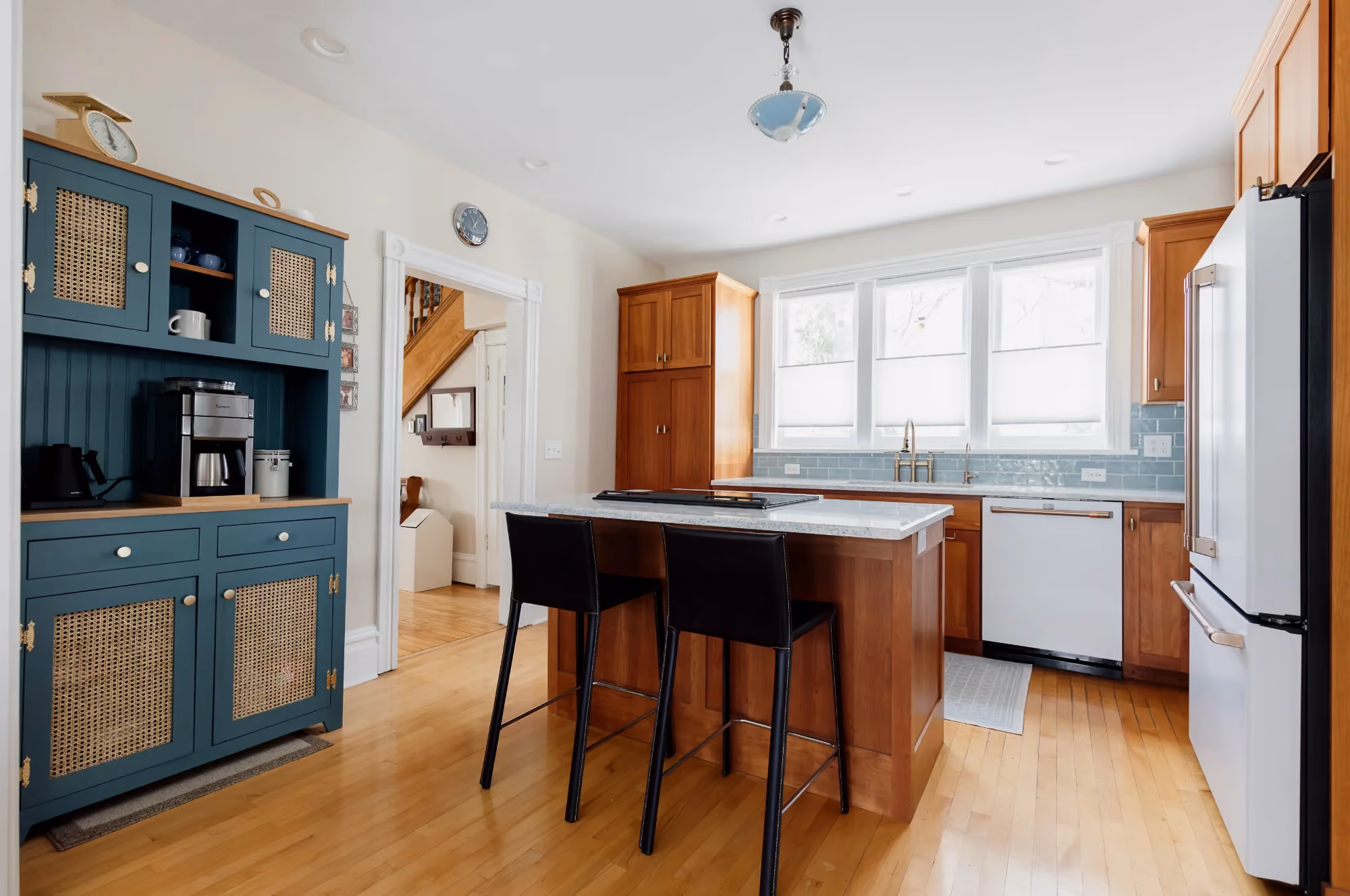 Kitchen with island table and blue cabinets