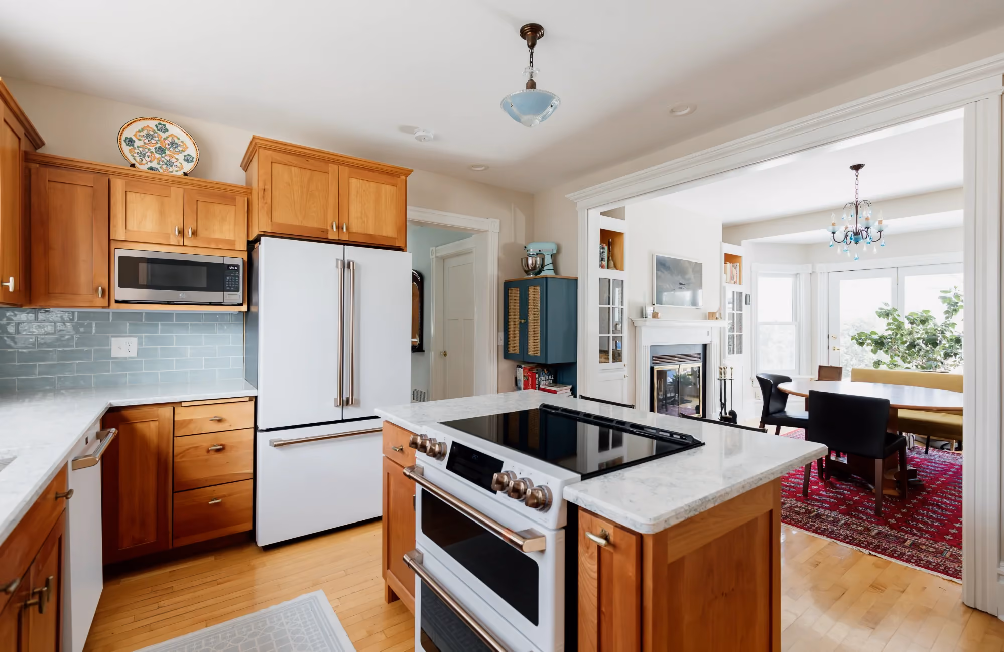 Bright kitchen with white cabinets and stainless steel stove