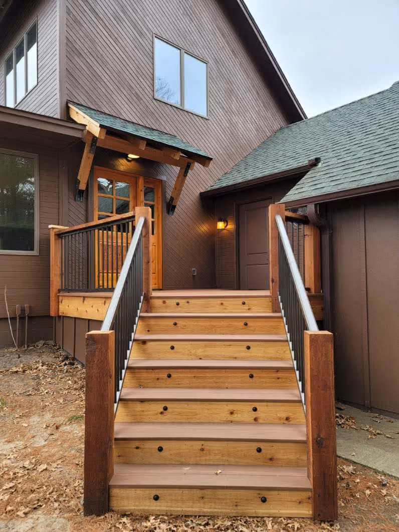 Wooden exterior staircase leading to a deck