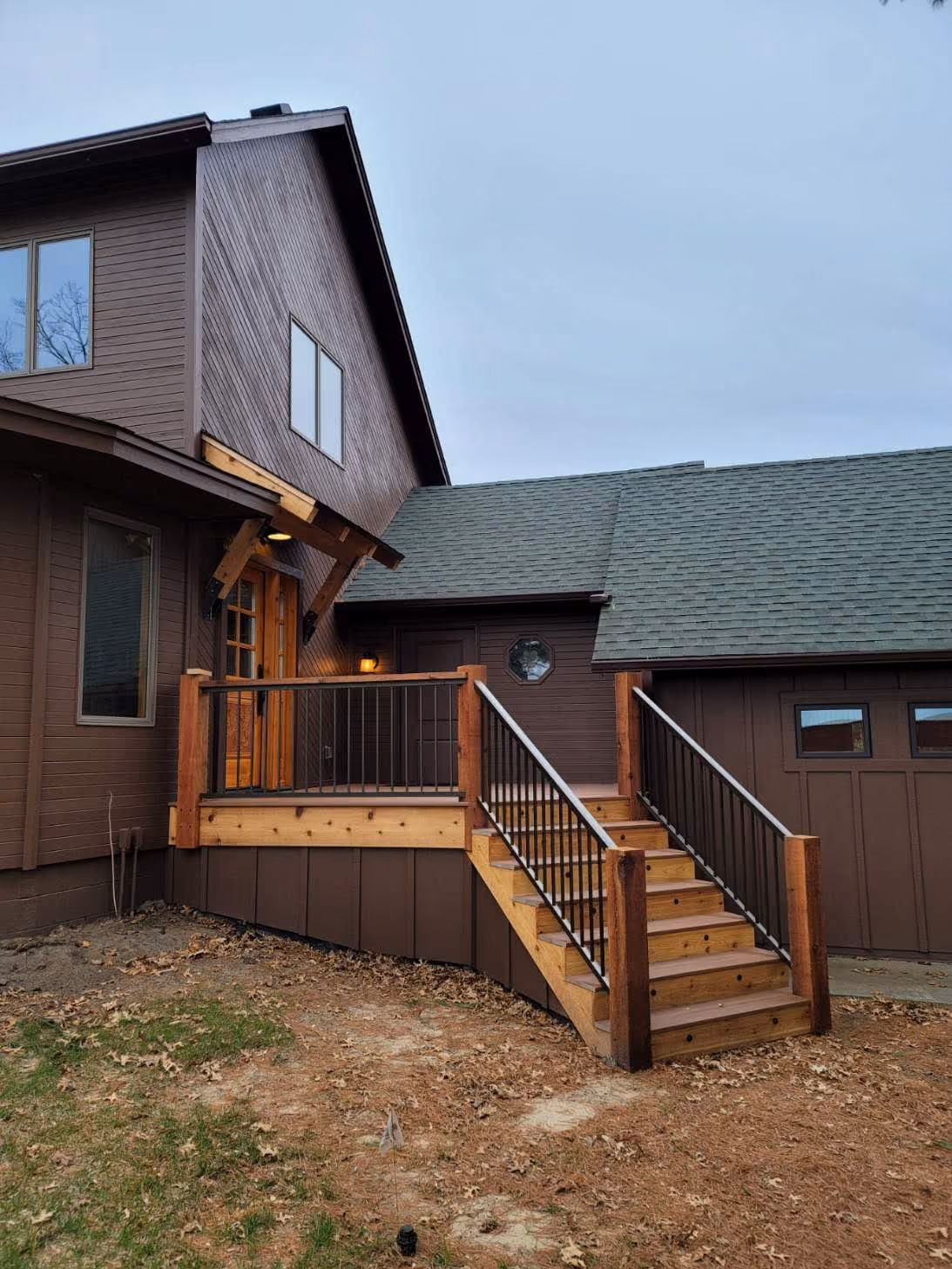 Backyard view with wooden stairs and deck