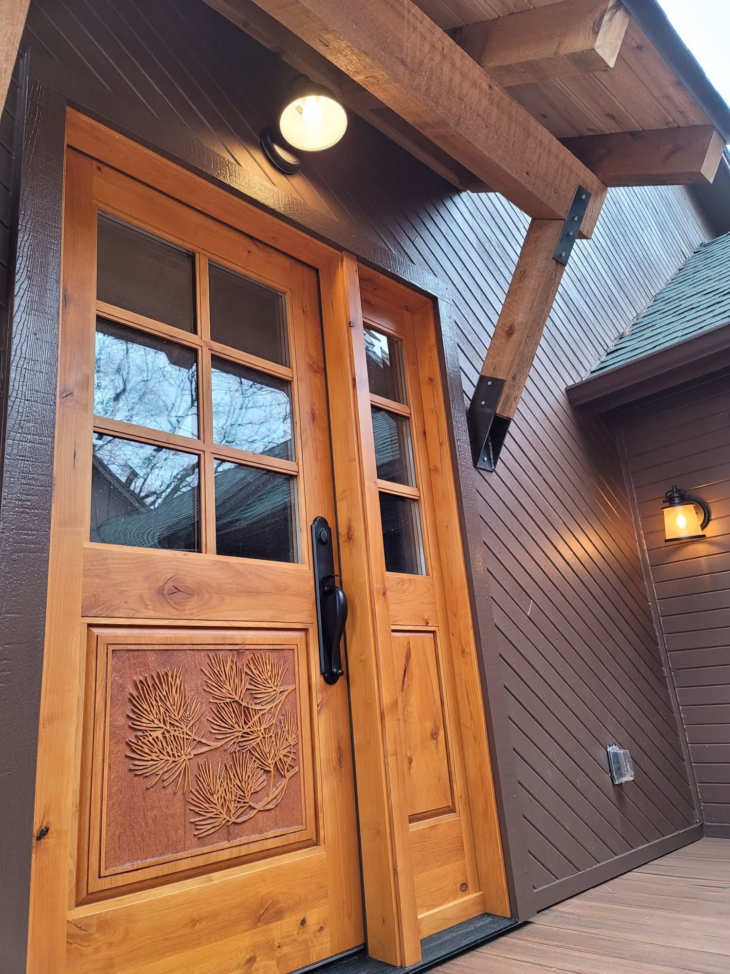 Wooden front door under covered entryway