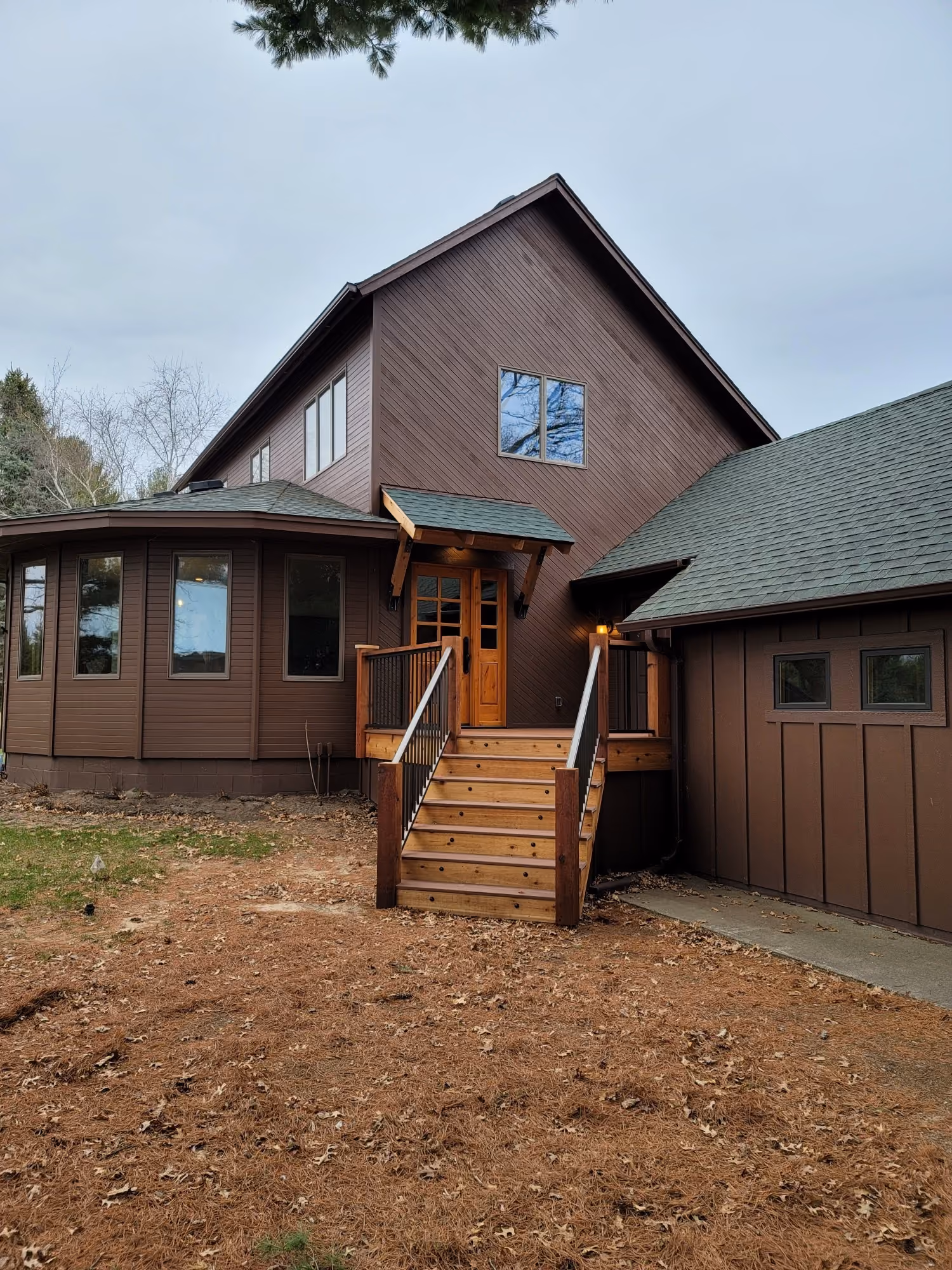 Two-story house exterior with stairs and deck