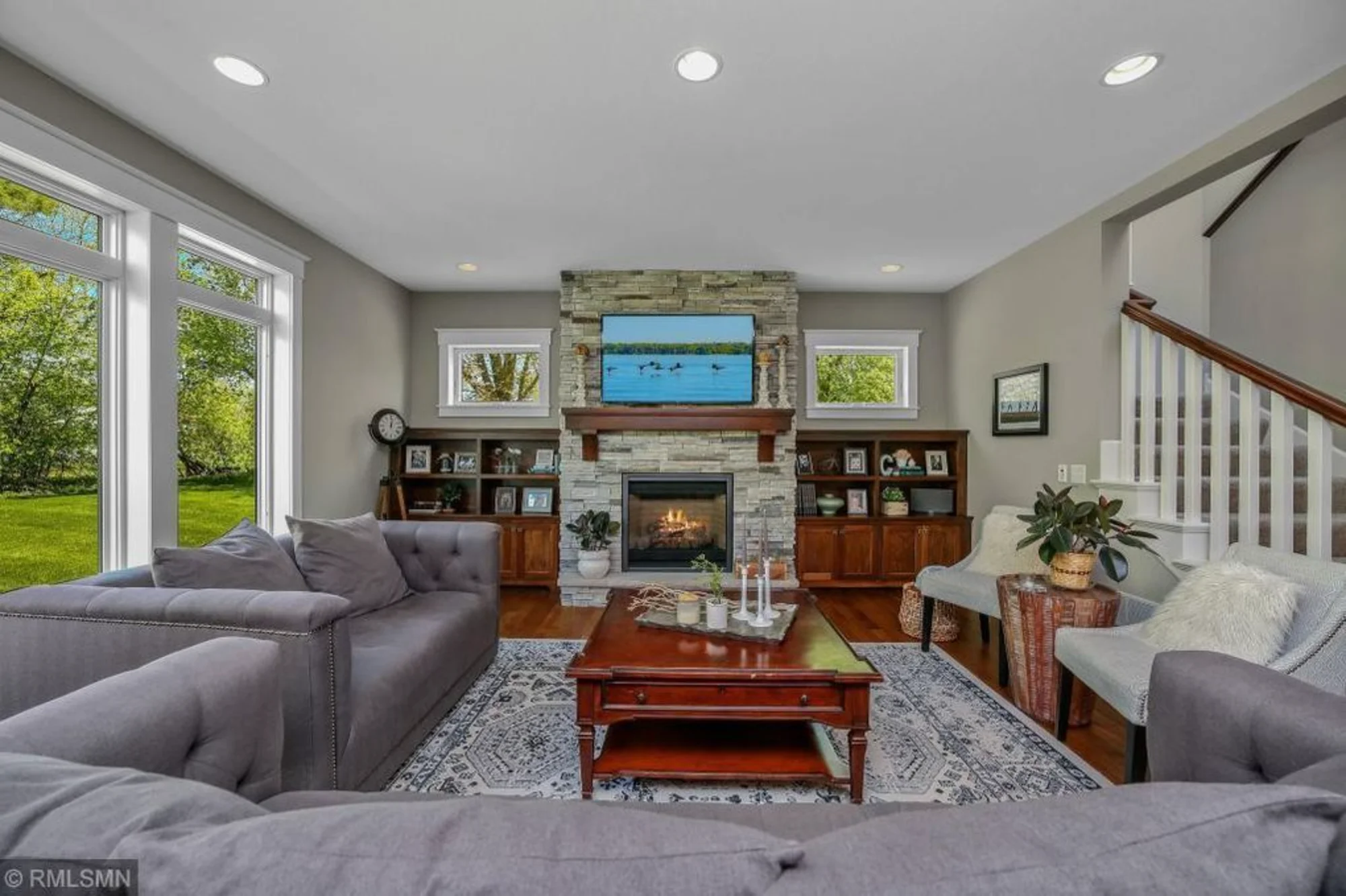 Family room with fireplace, sectional seating, and TV wall