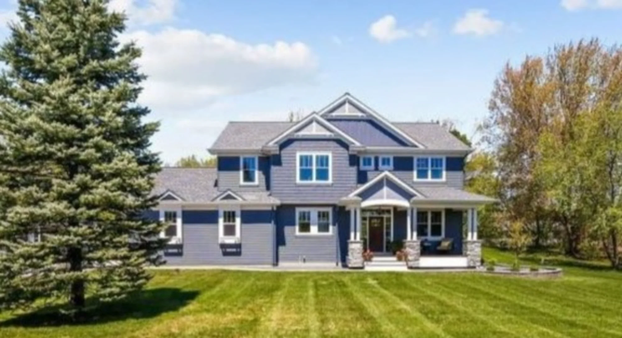Blue two-story house exterior with front lawn