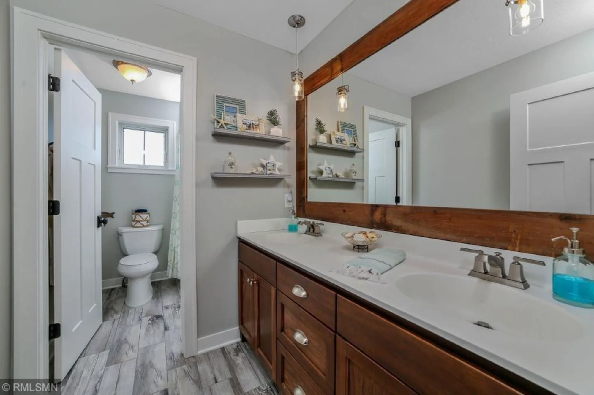 Bathroom vanity with double sink and toilet