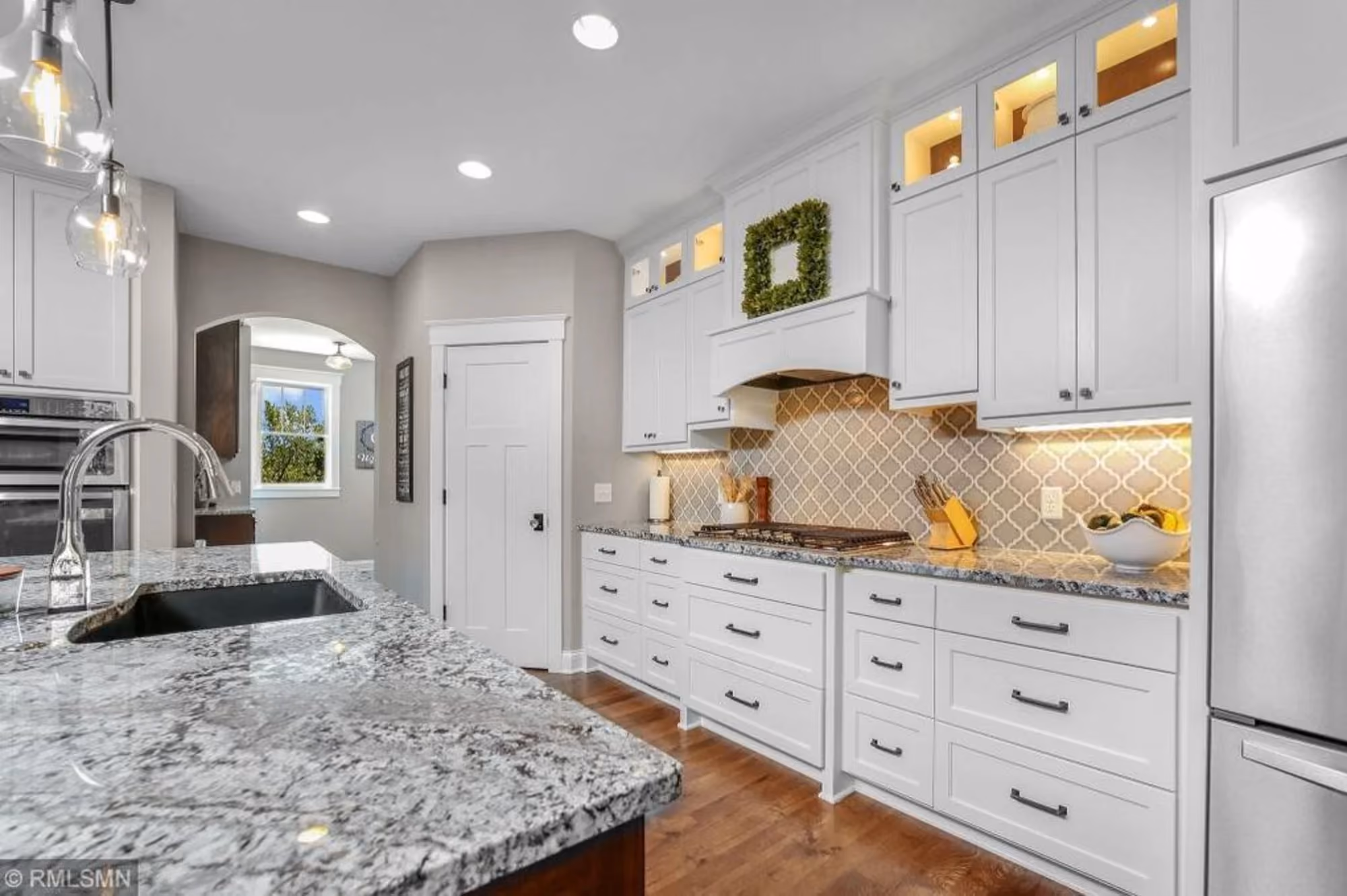 Bright white kitchen with granite island