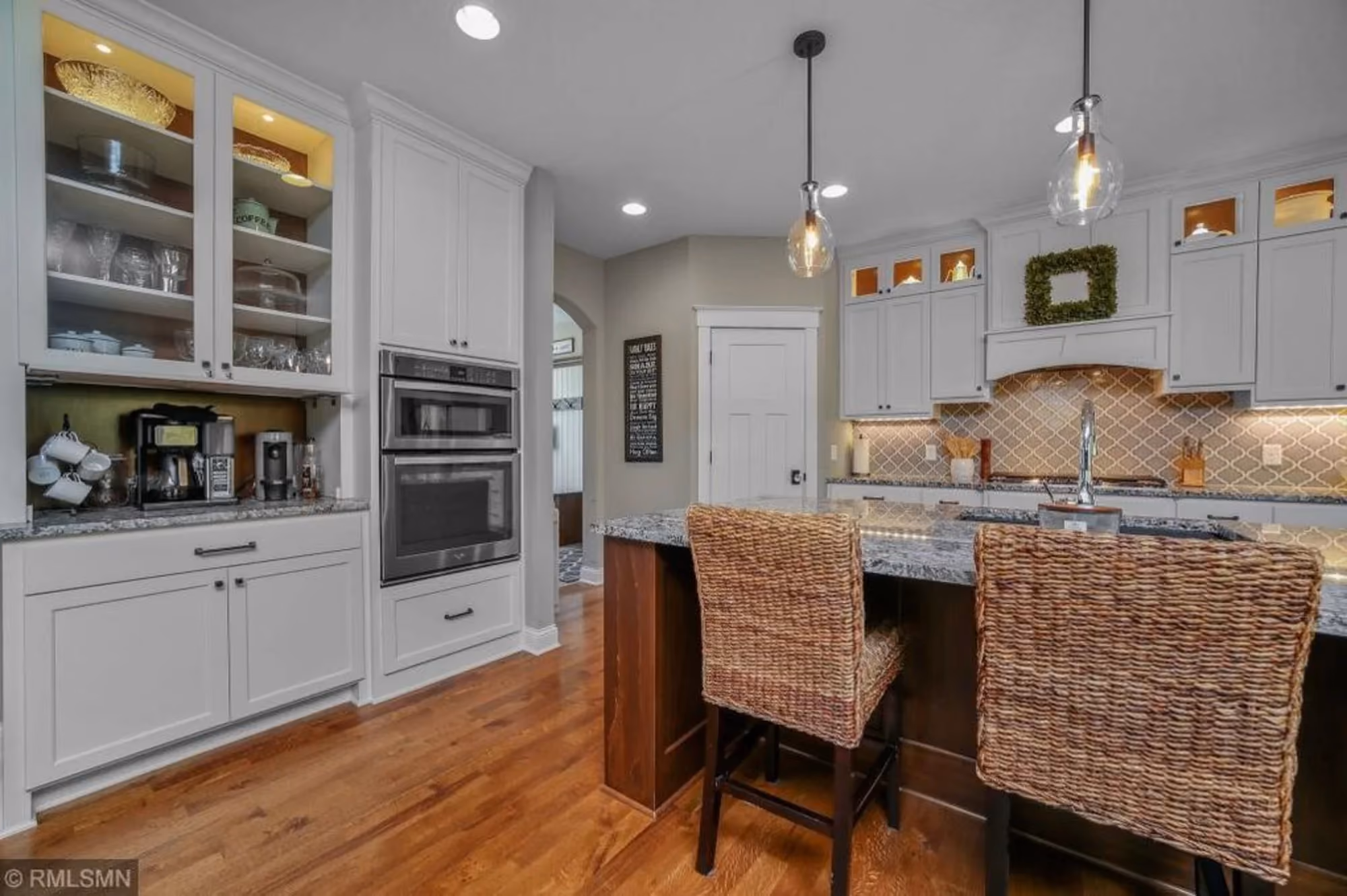 Modern kitchen with island and woven barstools