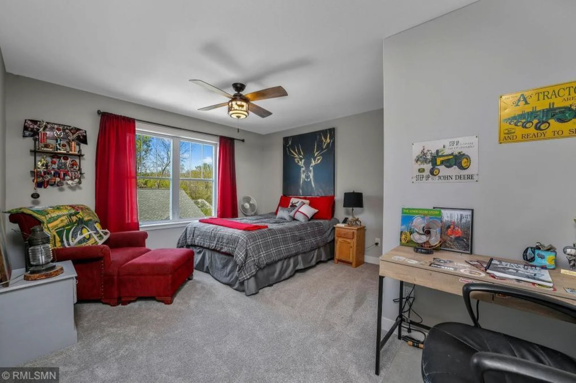 Bedroom with red curtains, desk, and TV