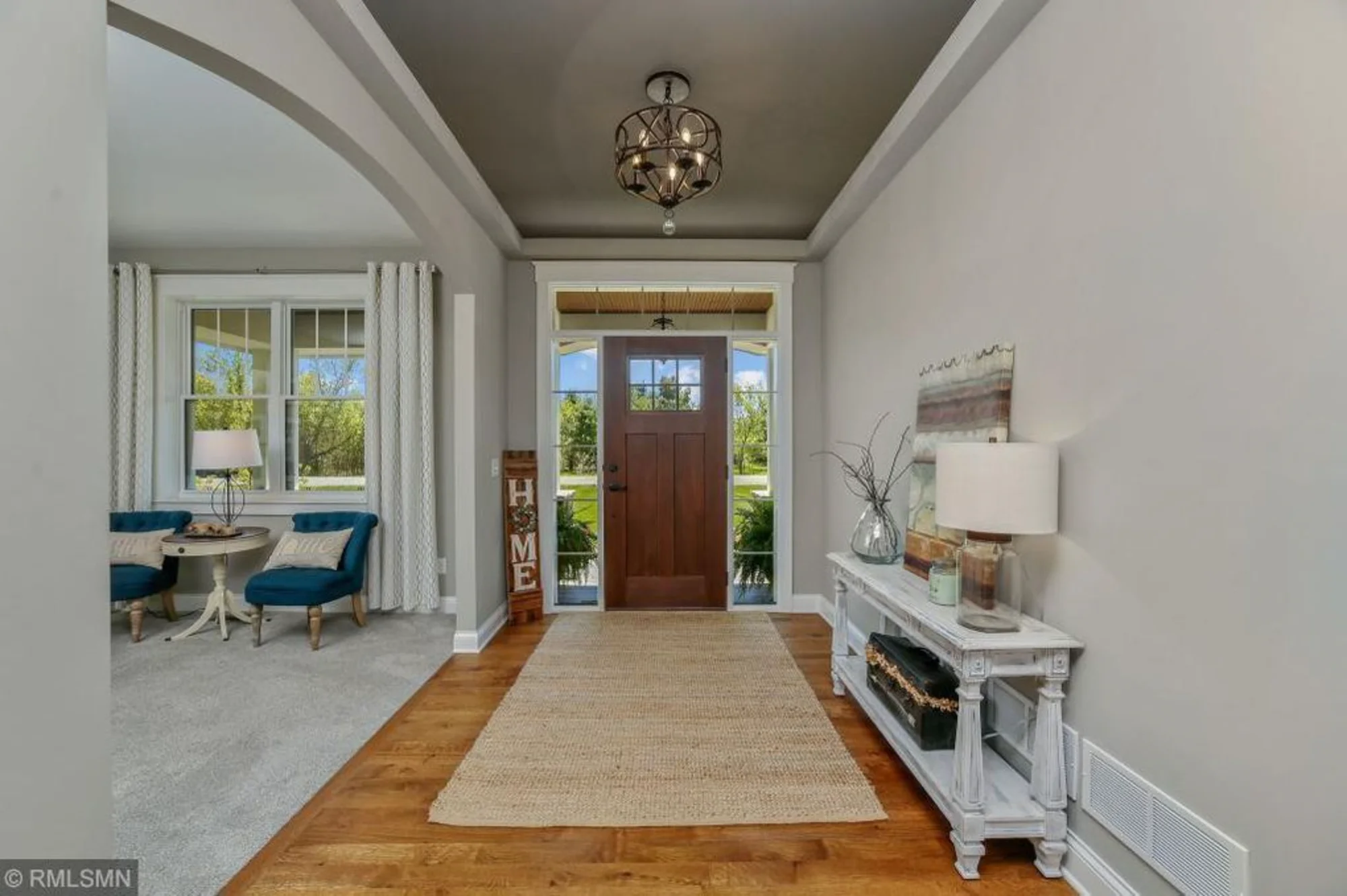 Bright foyer with front door and console table
