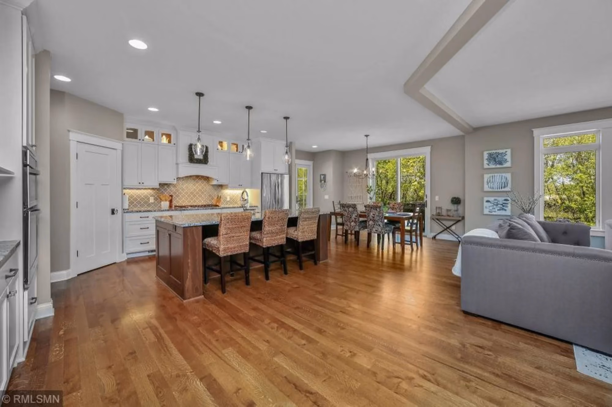 Open-plan dining and living room with hardwood floors