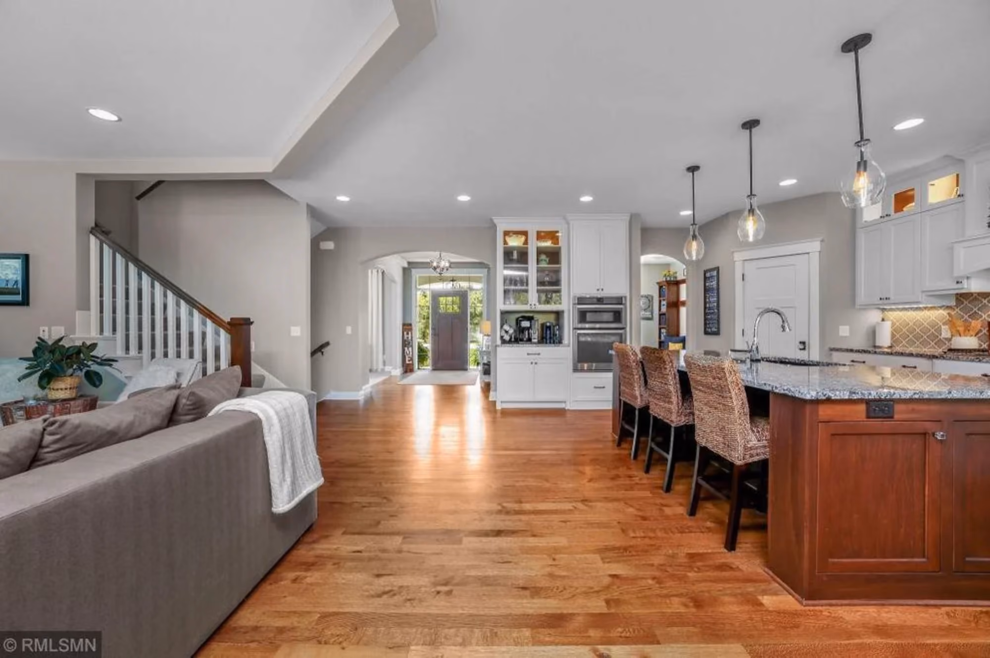Open-concept living room and kitchen with hardwood floors