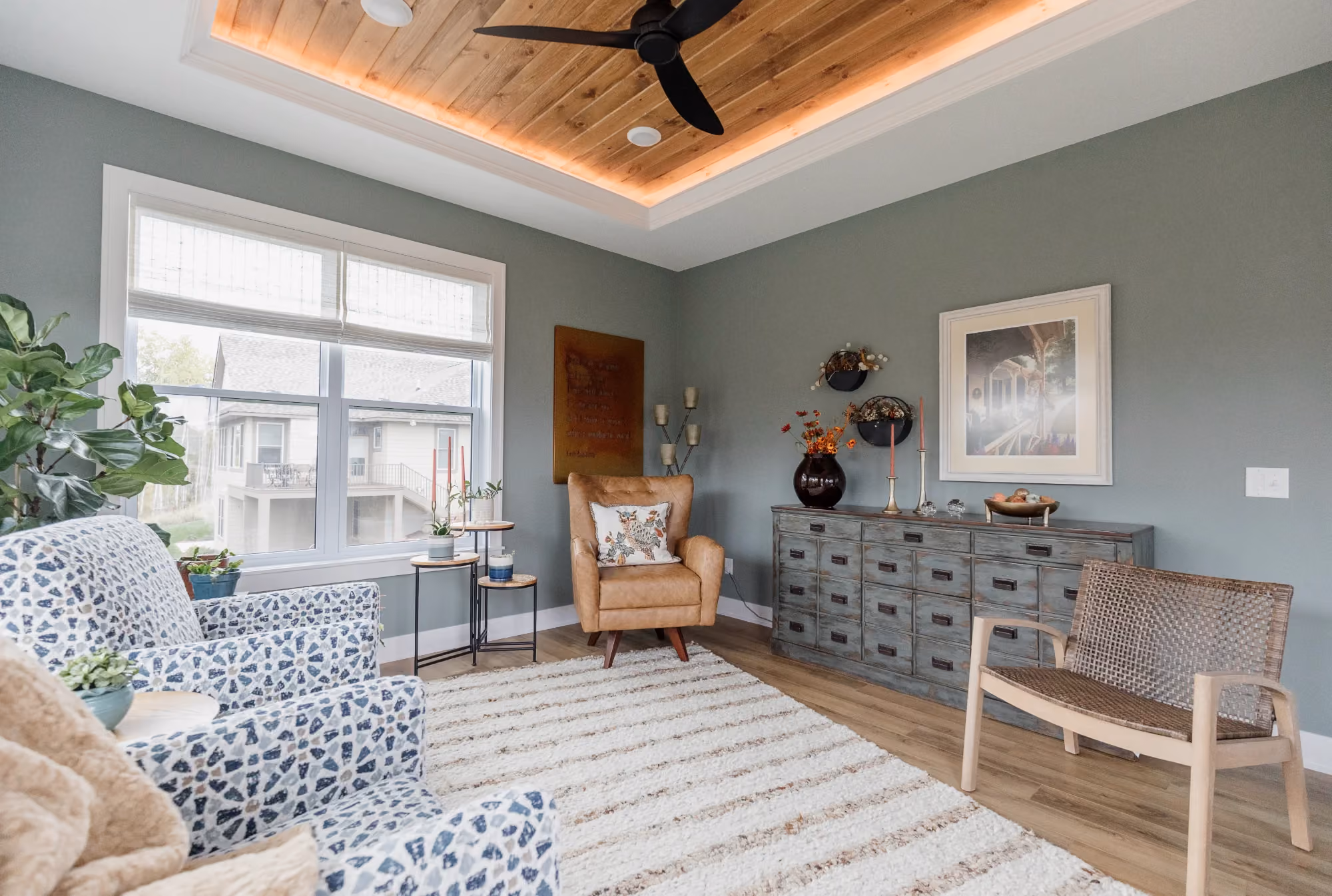 Living room with patterned sofa, armchair, and coffered ceiling