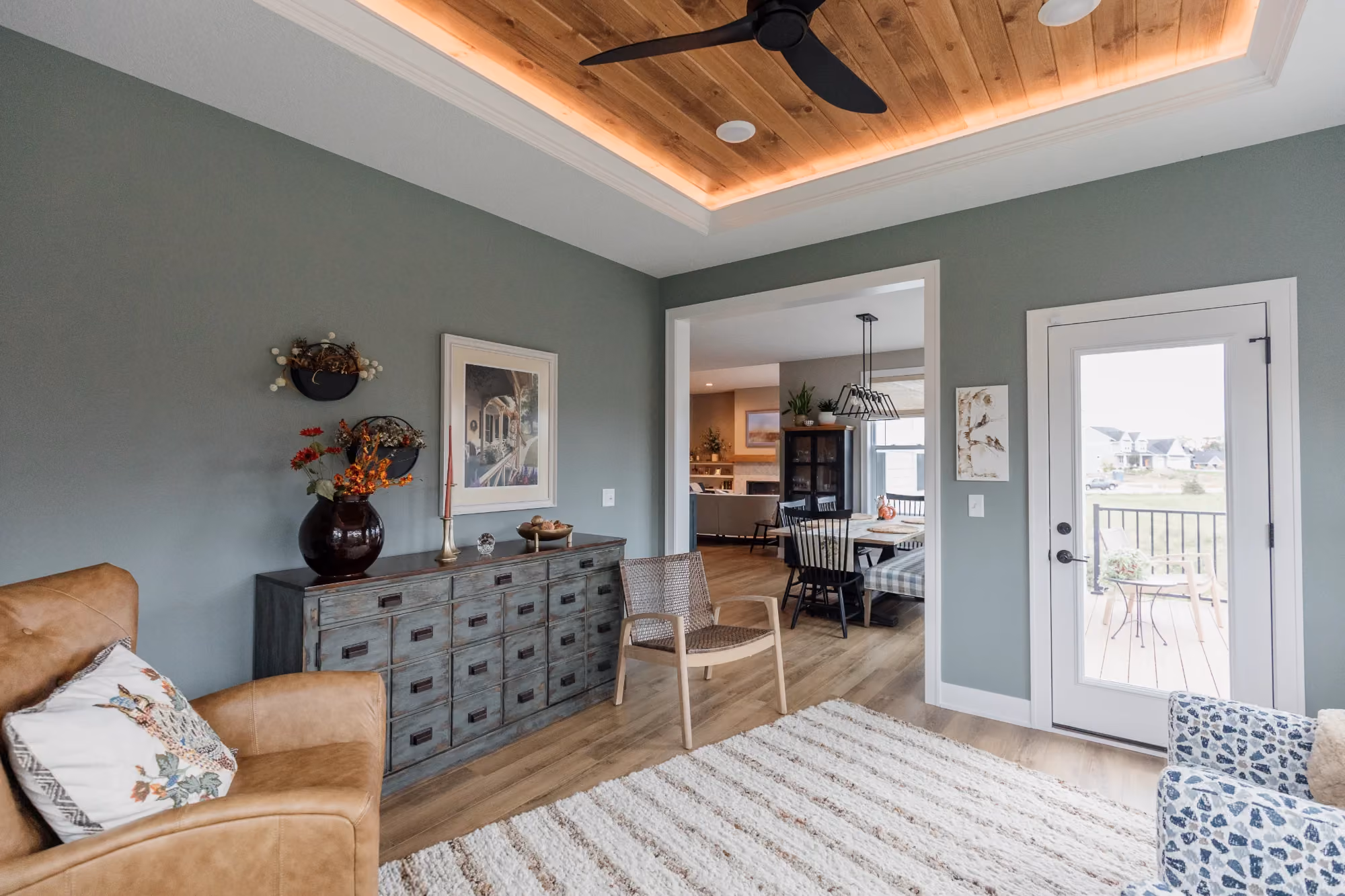 Living room view with media console and front door