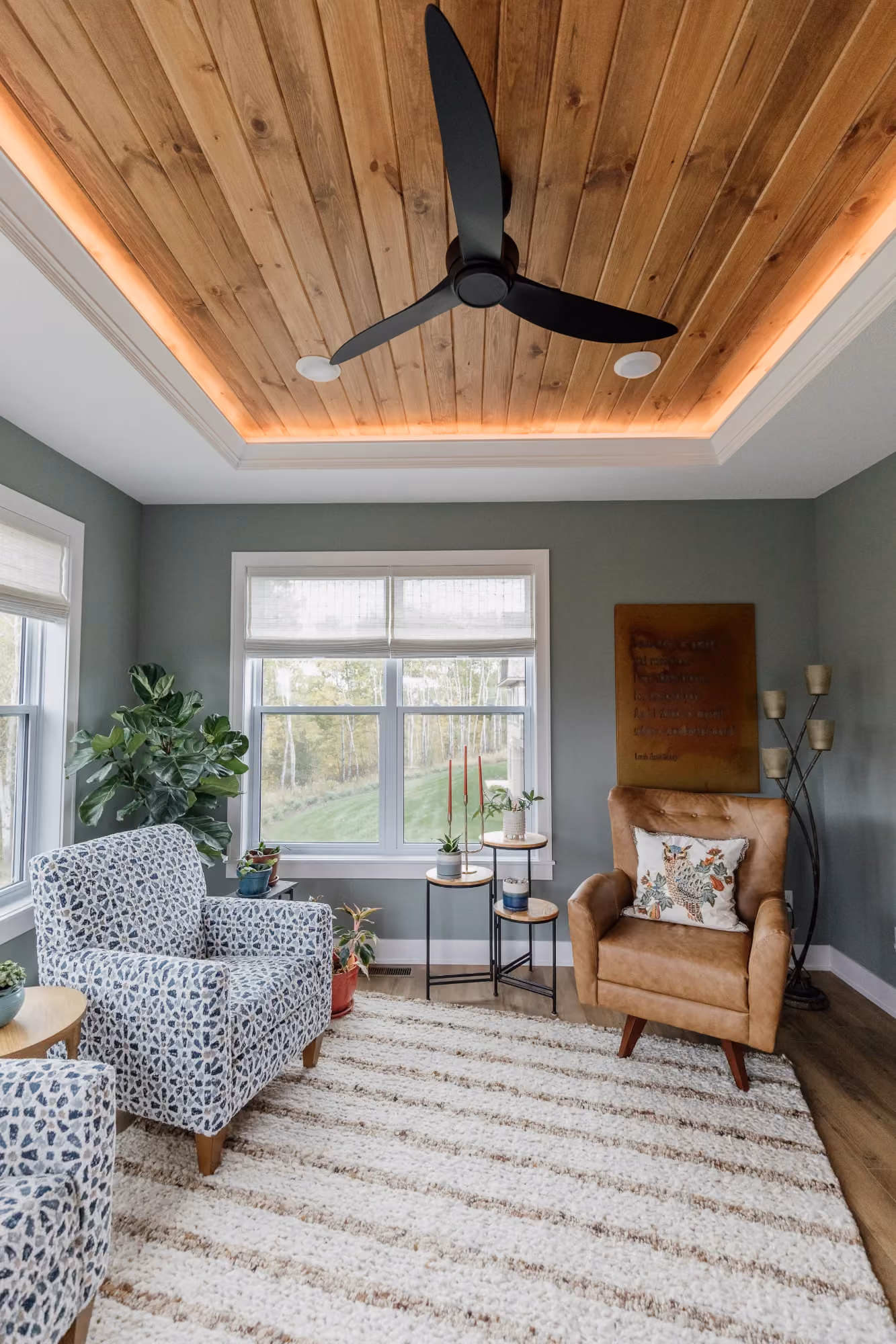 Living room with exposed wood ceiling and large windows