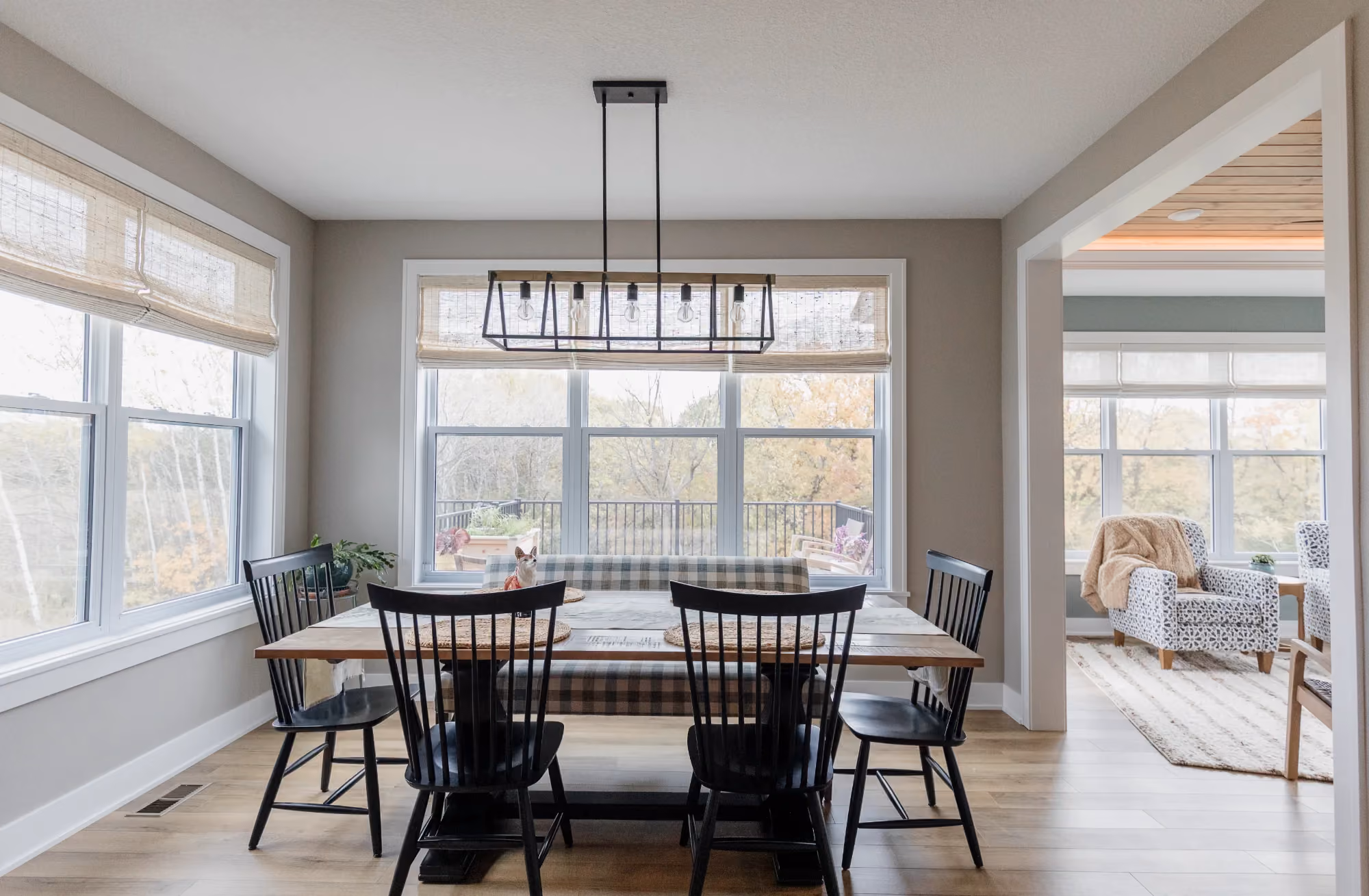 Dining table in sunroom with large windows
