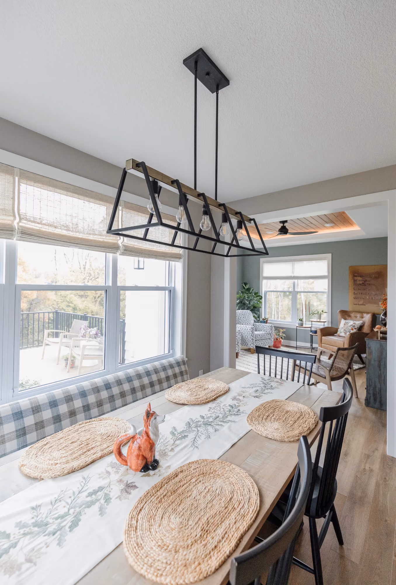 Dining area with black chandelier and round table
