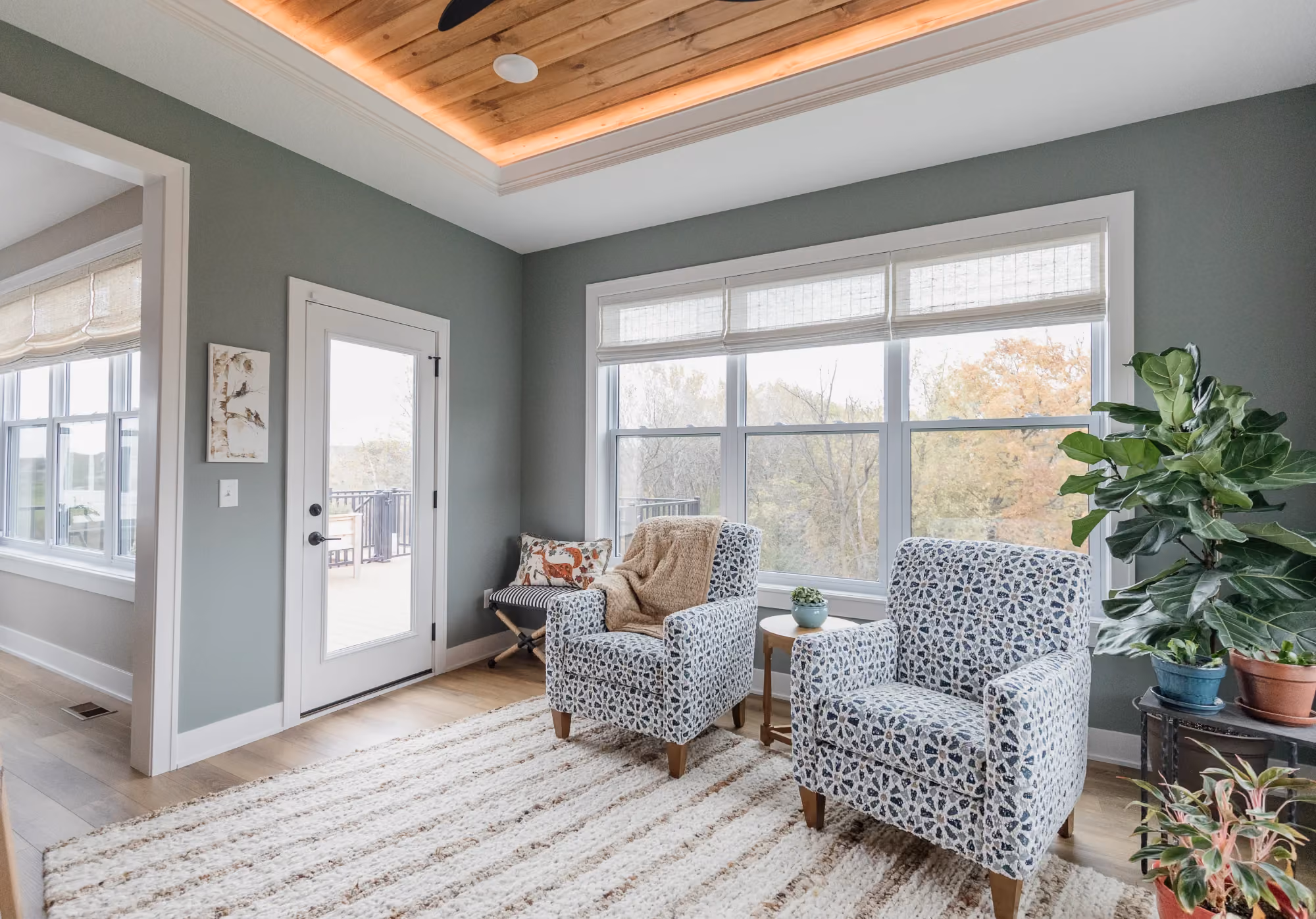 Bright living room with large windows and two armchairs