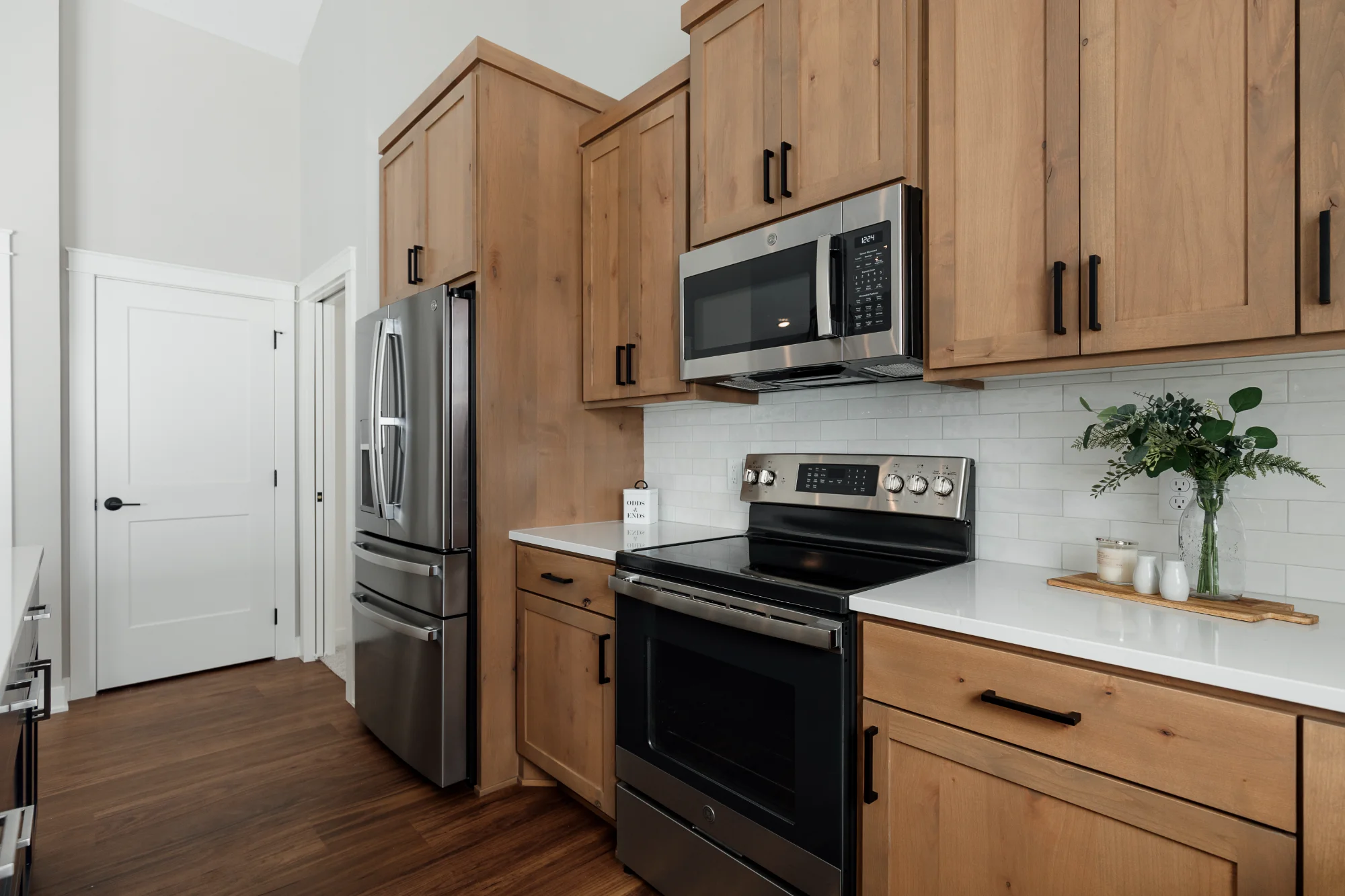 Kitchen corner with wood cabinets and stainless appliances
