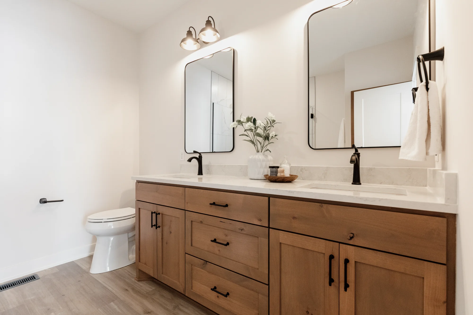 Modern bathroom vanity with double mirrors and white tile