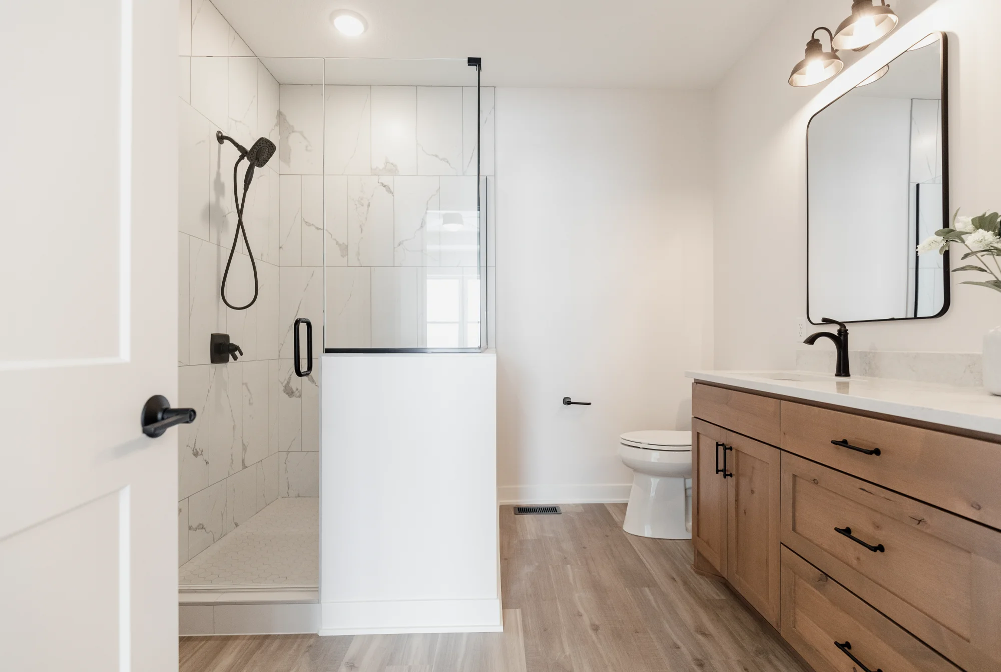 Walk-in shower with glass door and double vanity