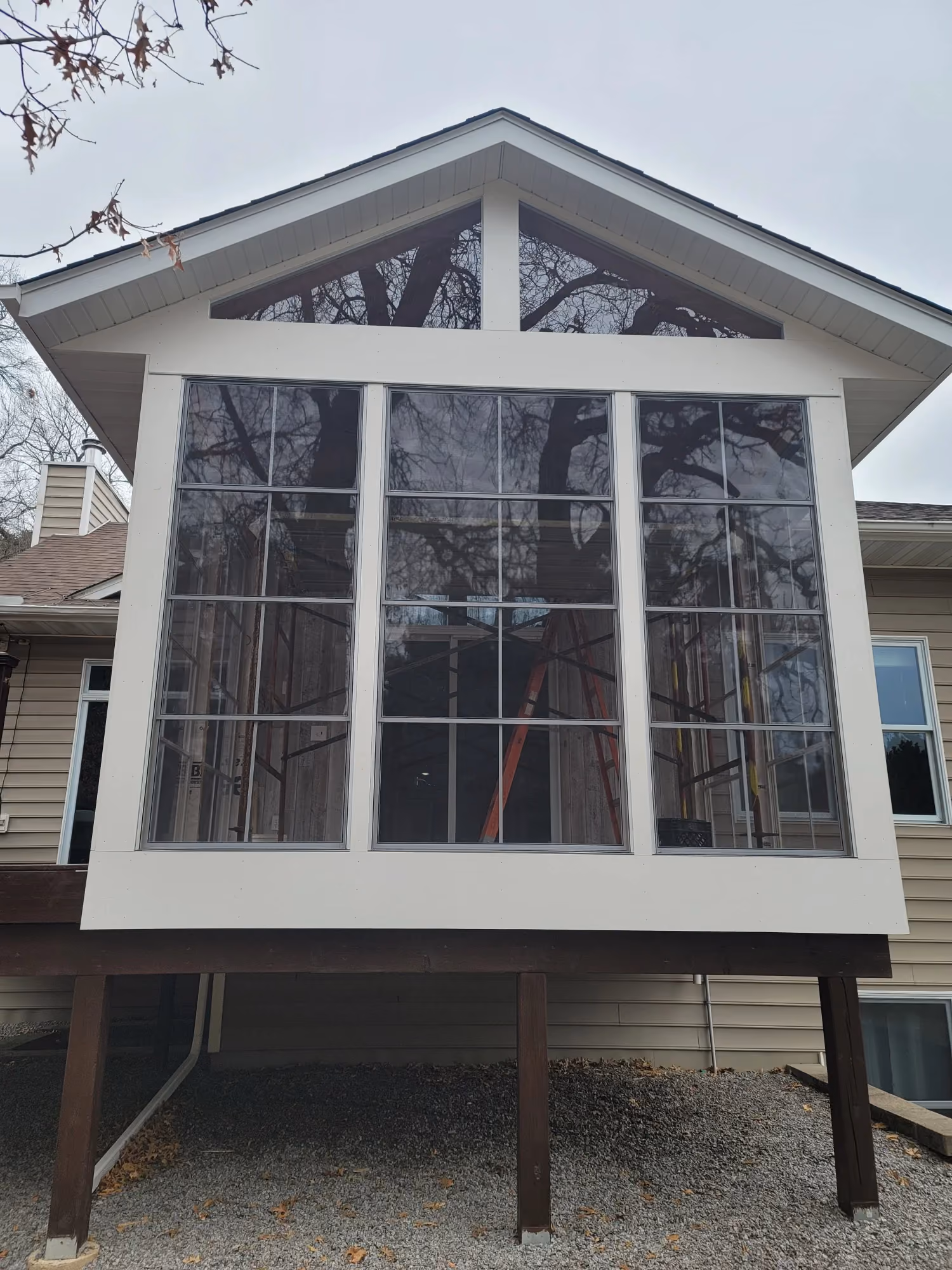 Front exterior view of house with large glass windows