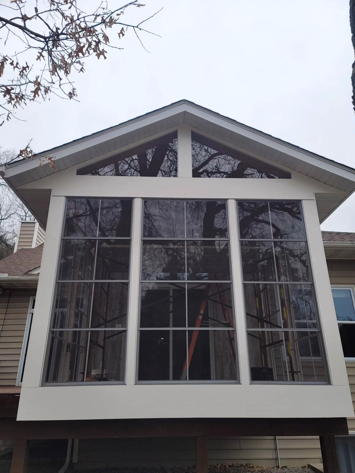 Screened porch with large windows and gable roof