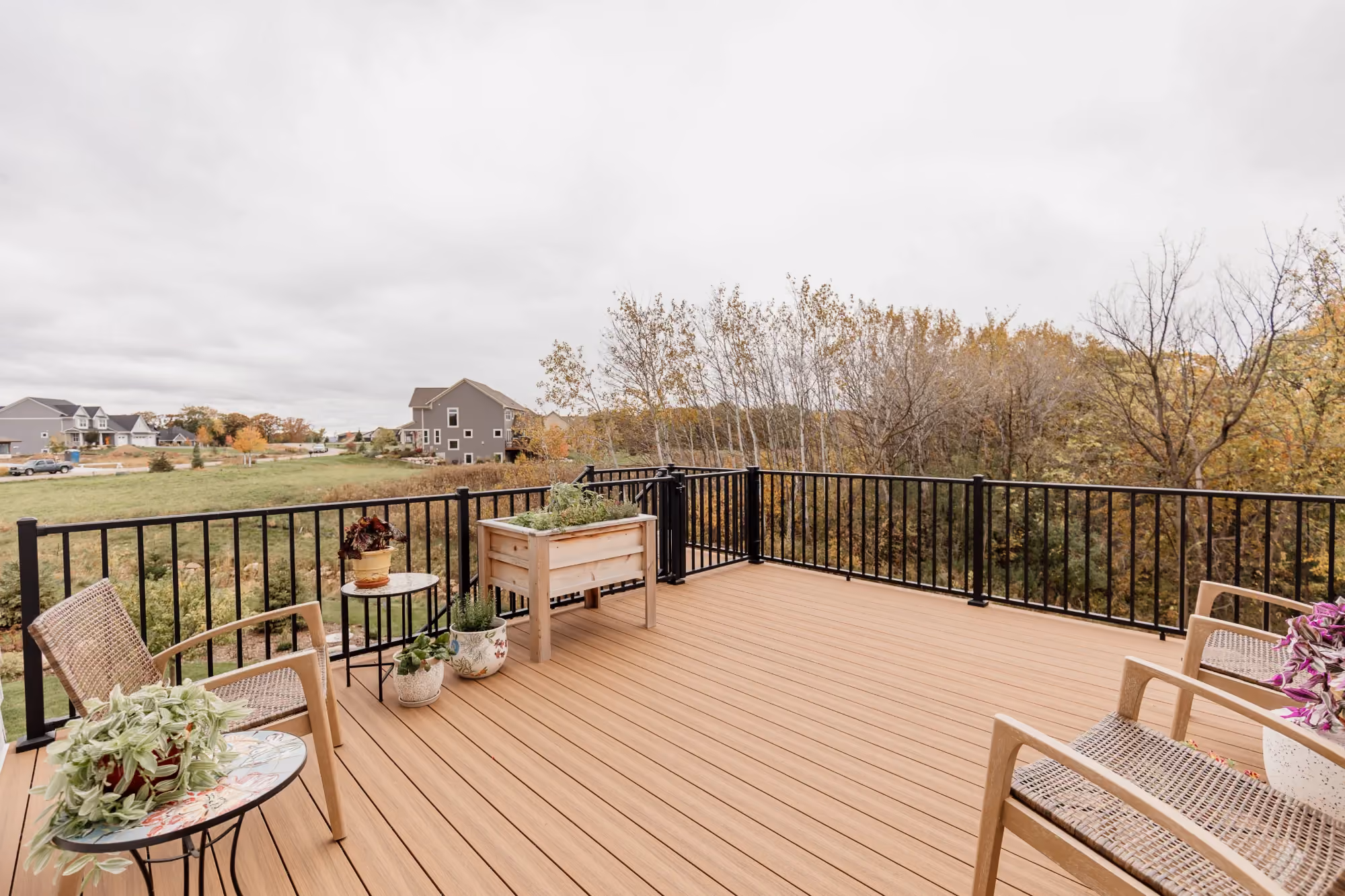 Spacious wooden deck with outdoor seating and view