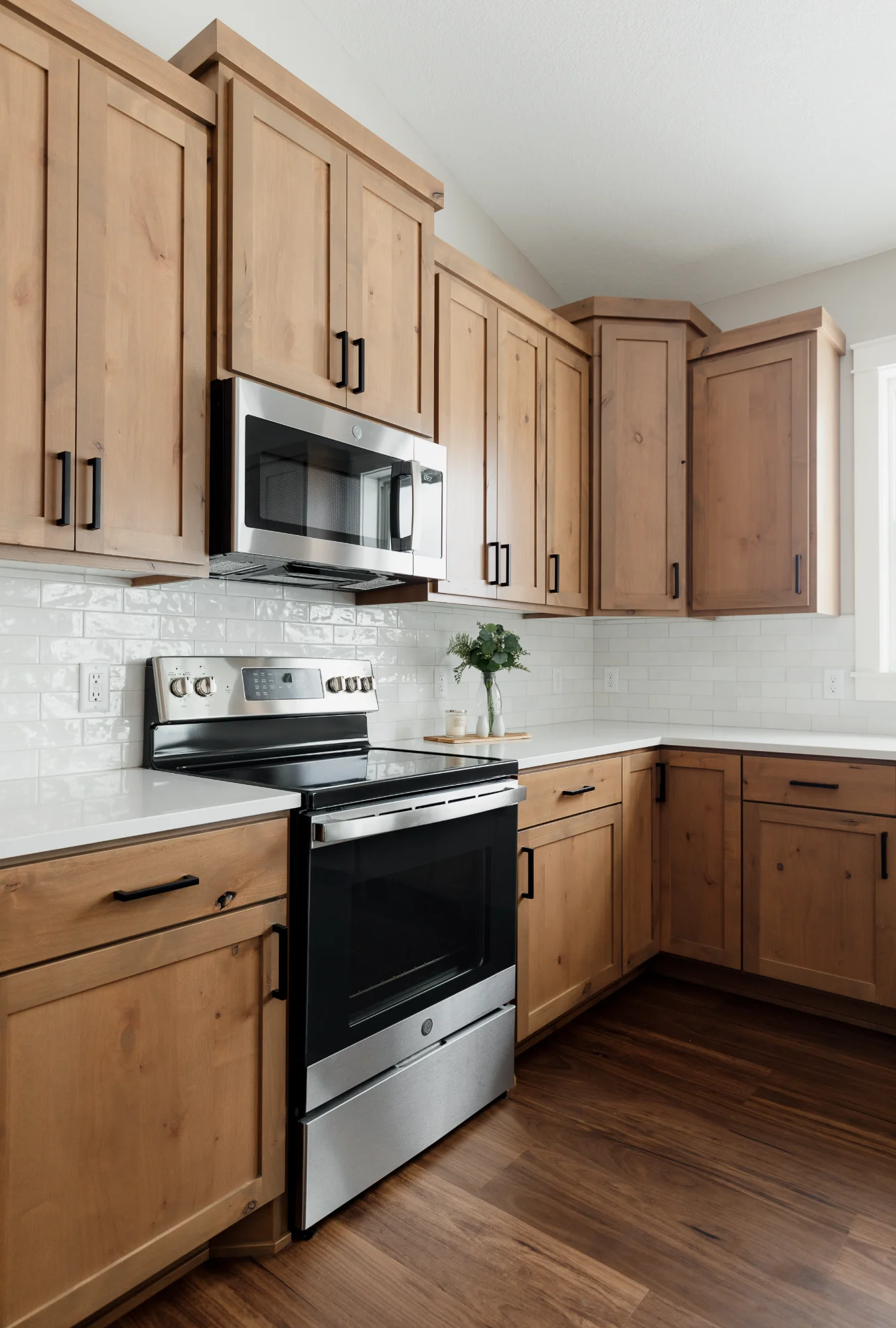 Compact kitchen corner with stove and wood cabinets