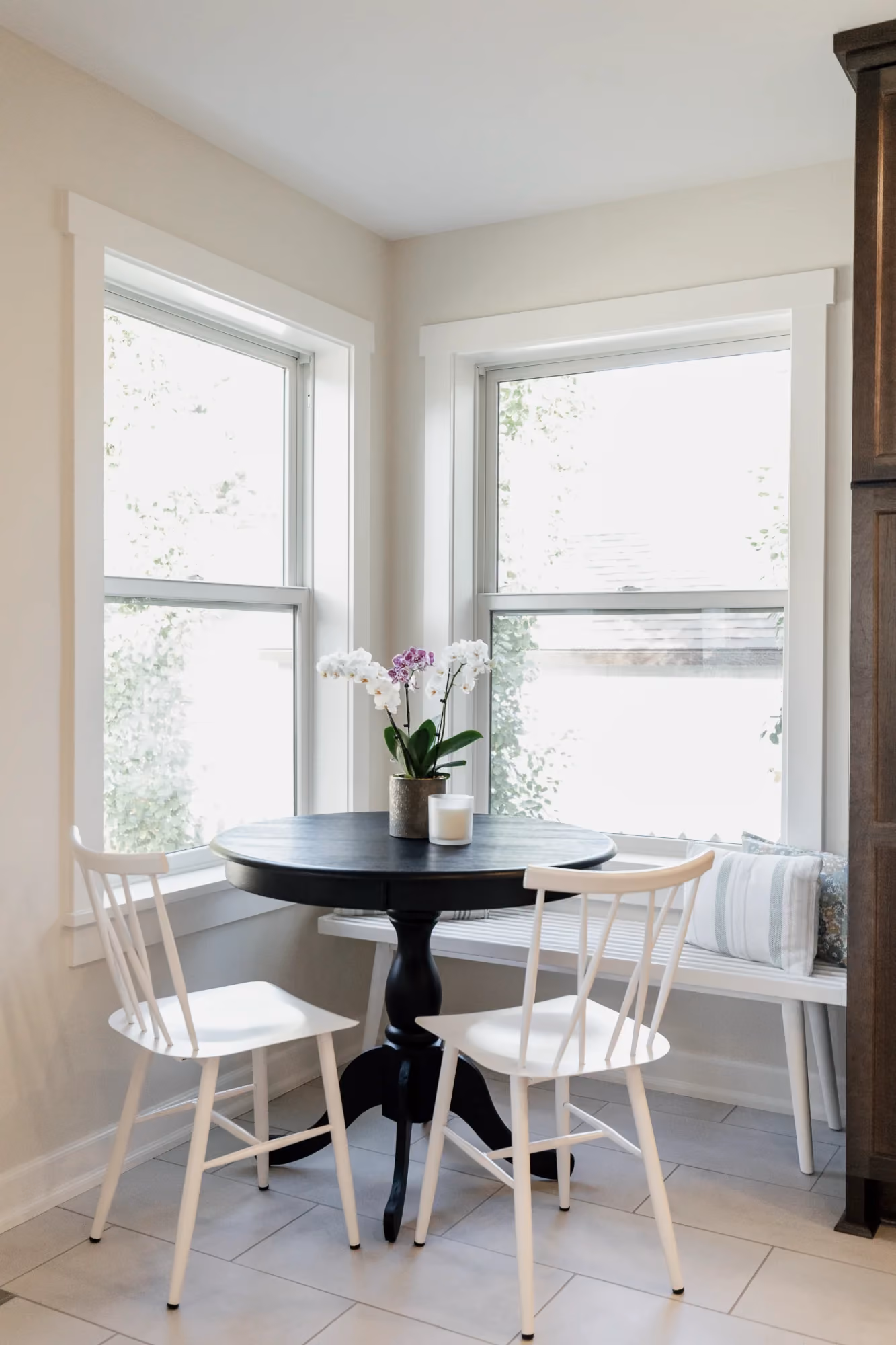 Small dining nook by windows with round table and chairs