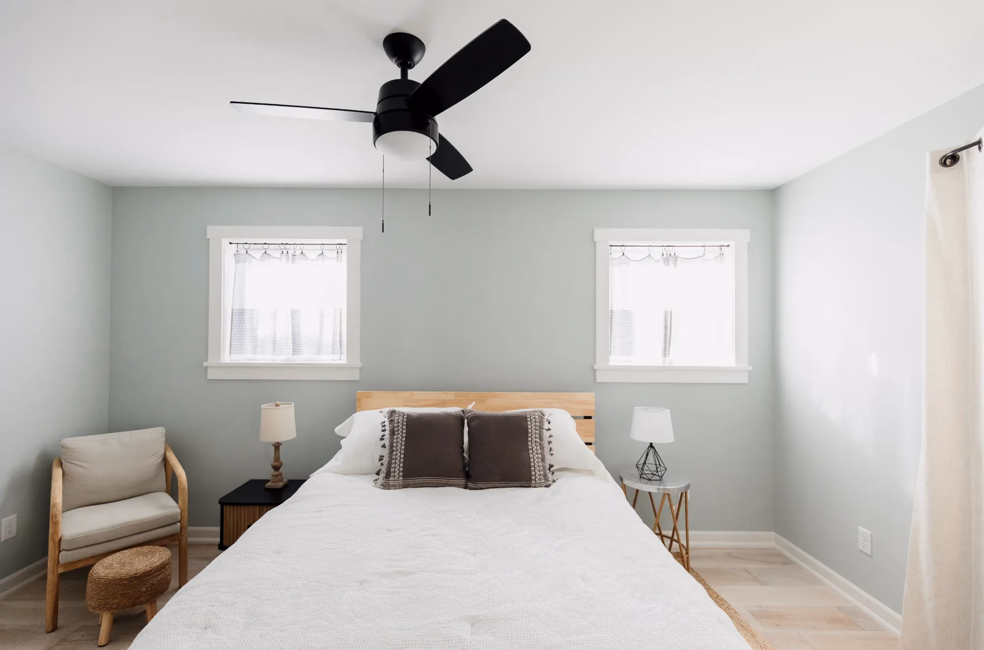 Bedroom with ceiling fan and two windows