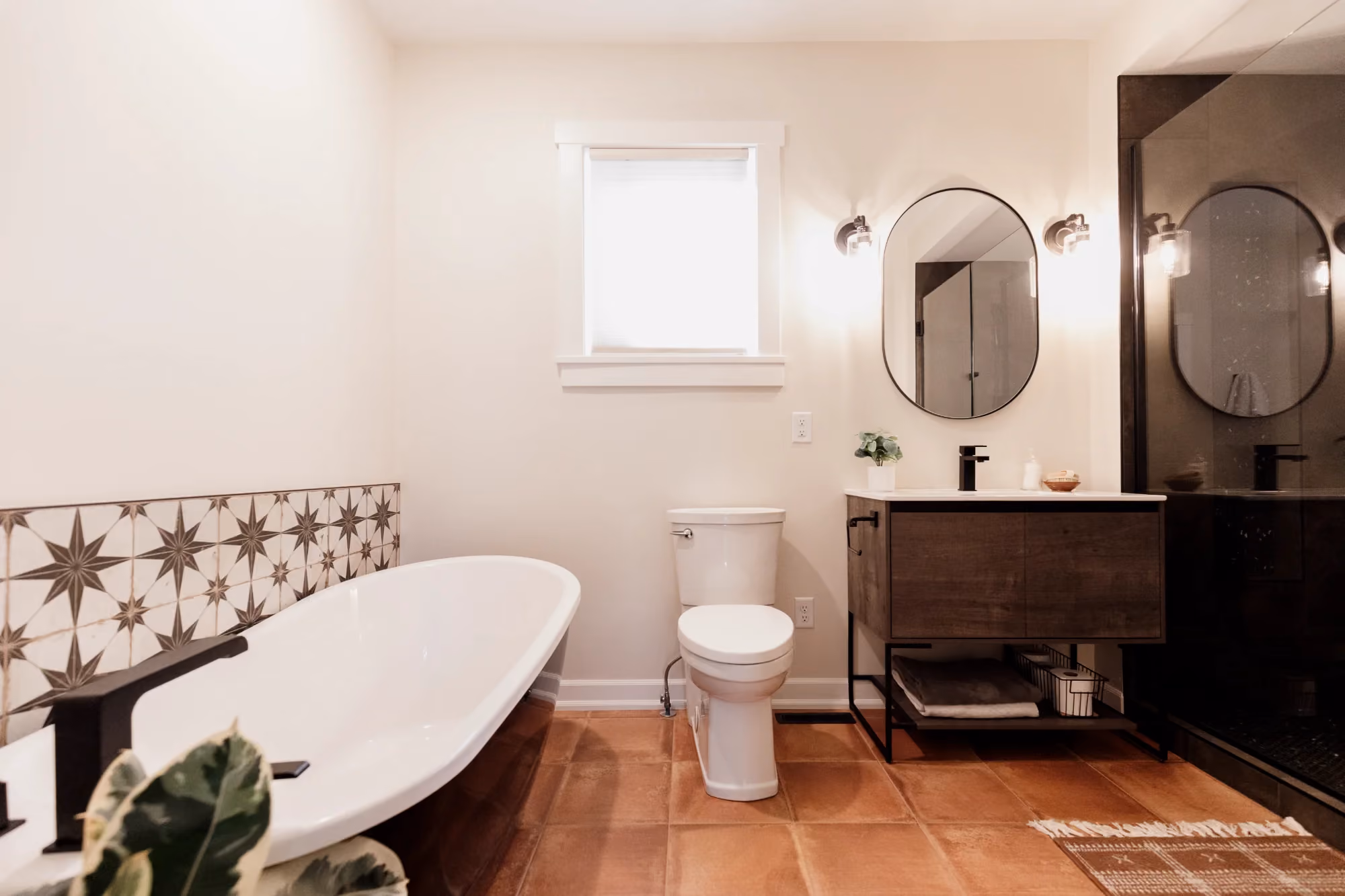 Bathroom with freestanding tub, toilet, and double vanity